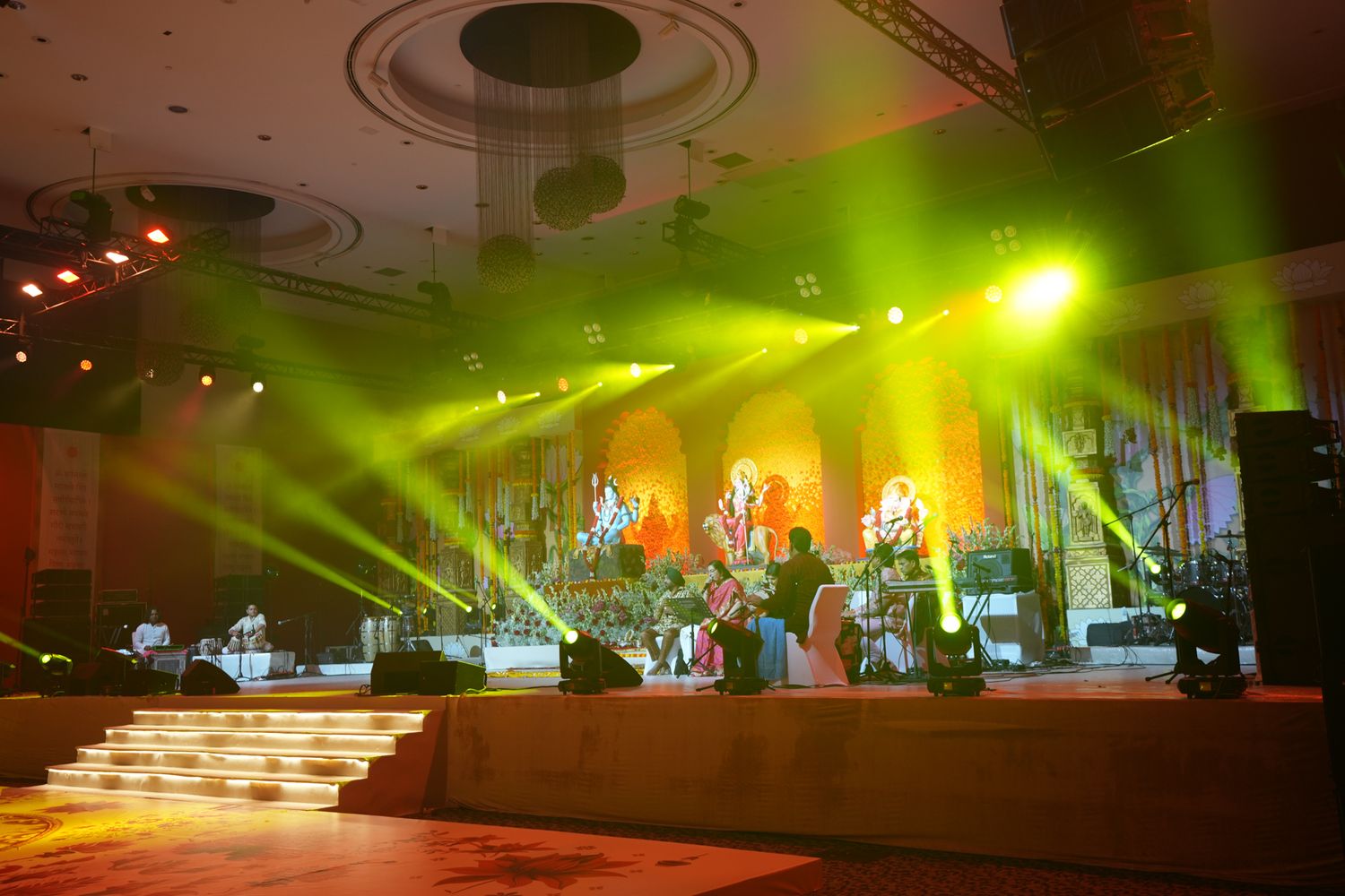 hanging marigold wall with mehndi backdrop designed to elevate the ambiance of a high-end multicultural wedding celebration.