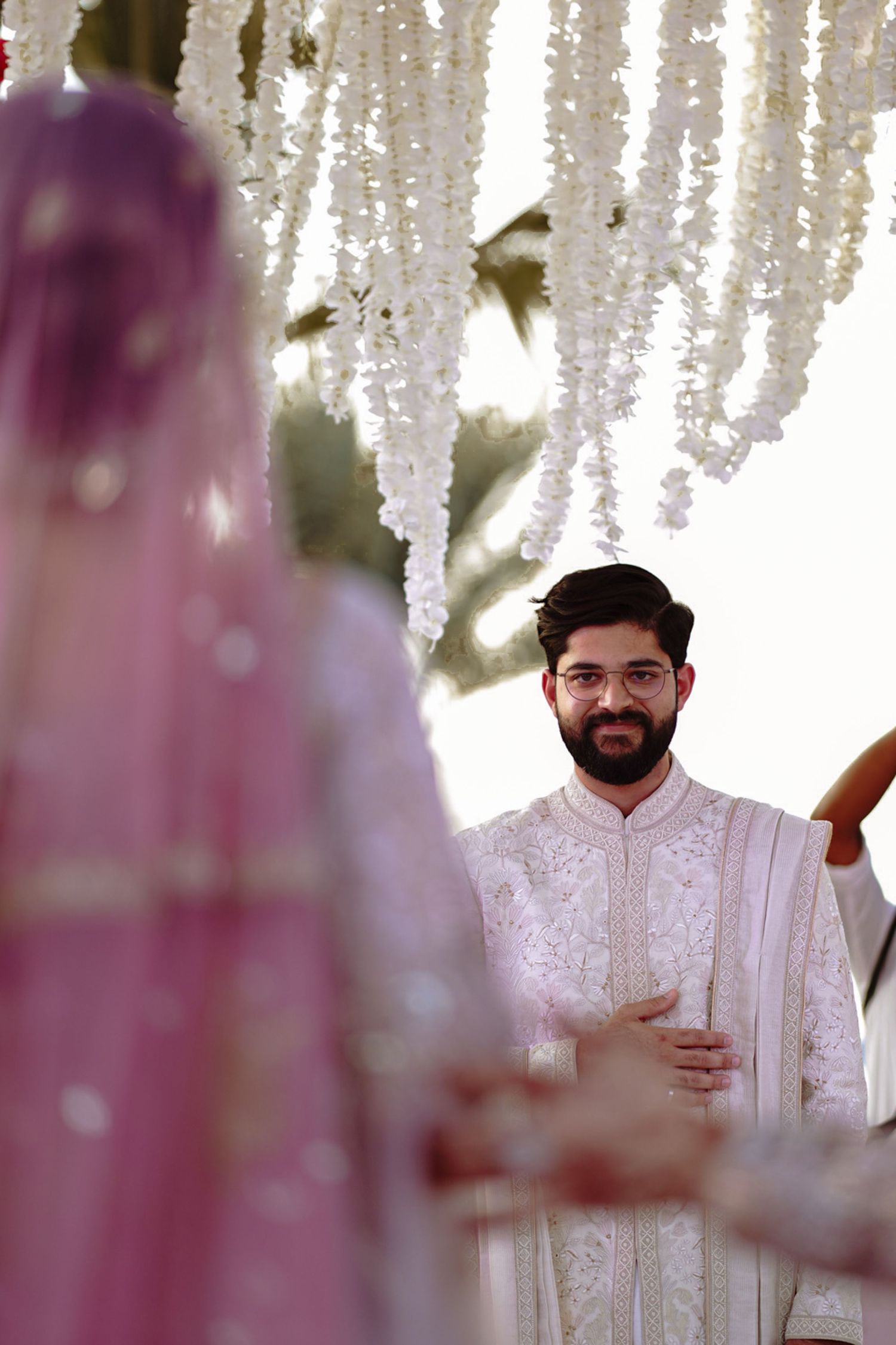 Elegant South Asian engagement photo with the couple wearing sherwani and saree, exuding classic romance.