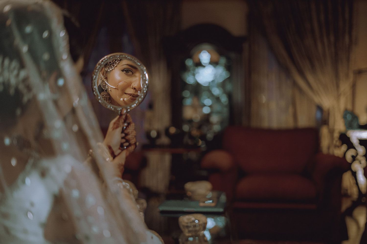 Classic moment before the first look, surrounded by family and vibrant florals.