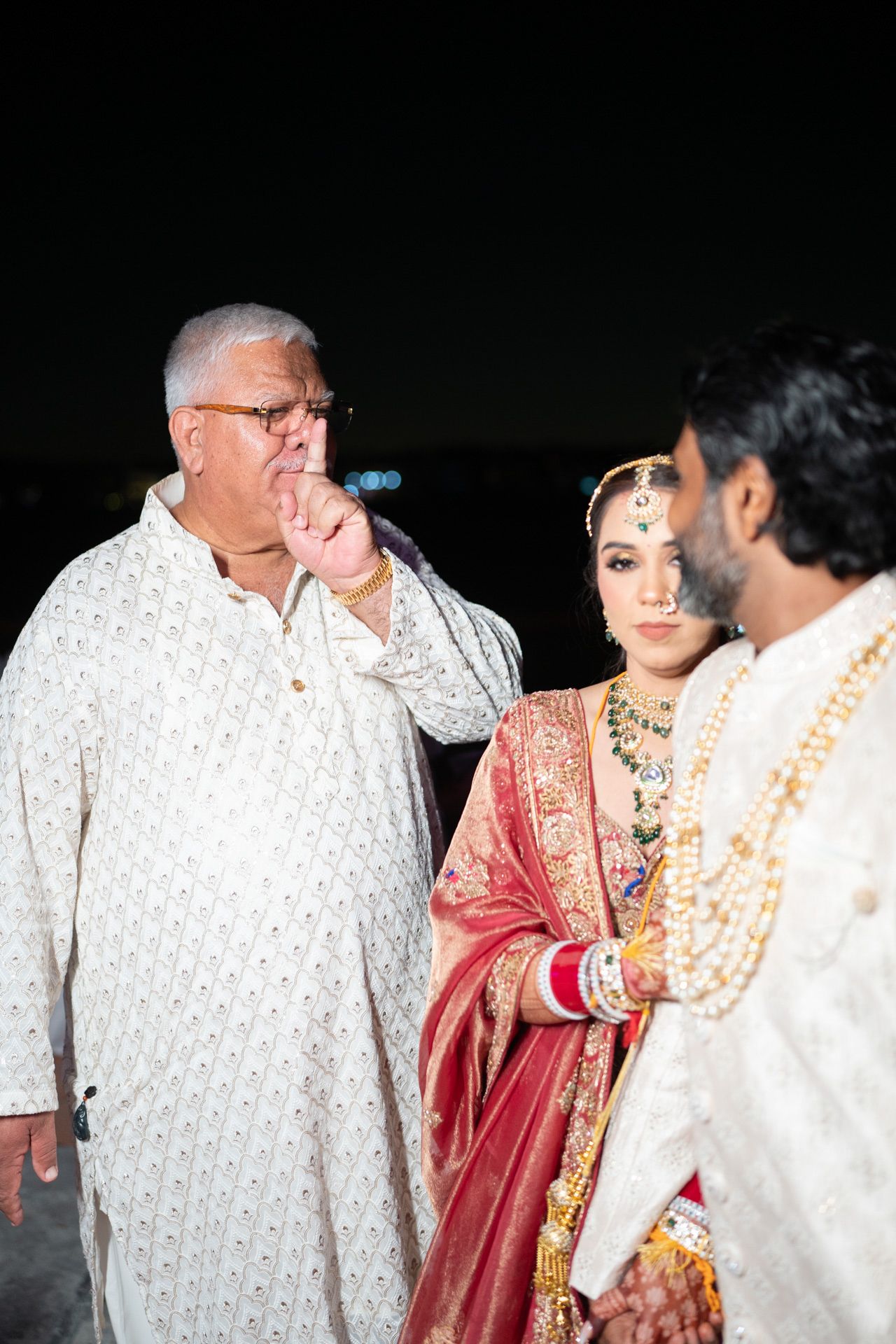 Heartfelt moment captured: elder giving traditional blessings during baraat, reflecting the deep love and tradition of South Asian weddings.