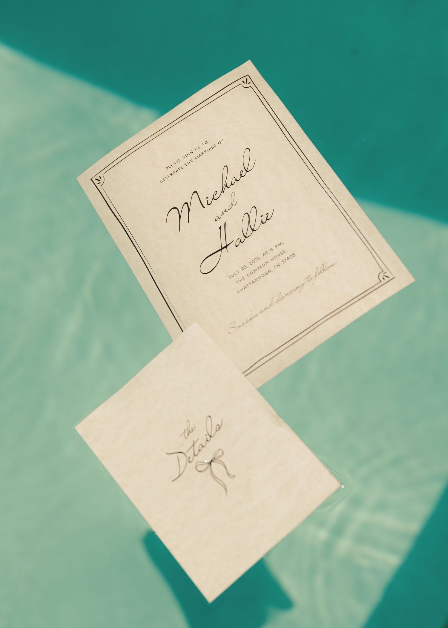 Wedding invitation cards for Michael and Hallie suspended against a teal background.