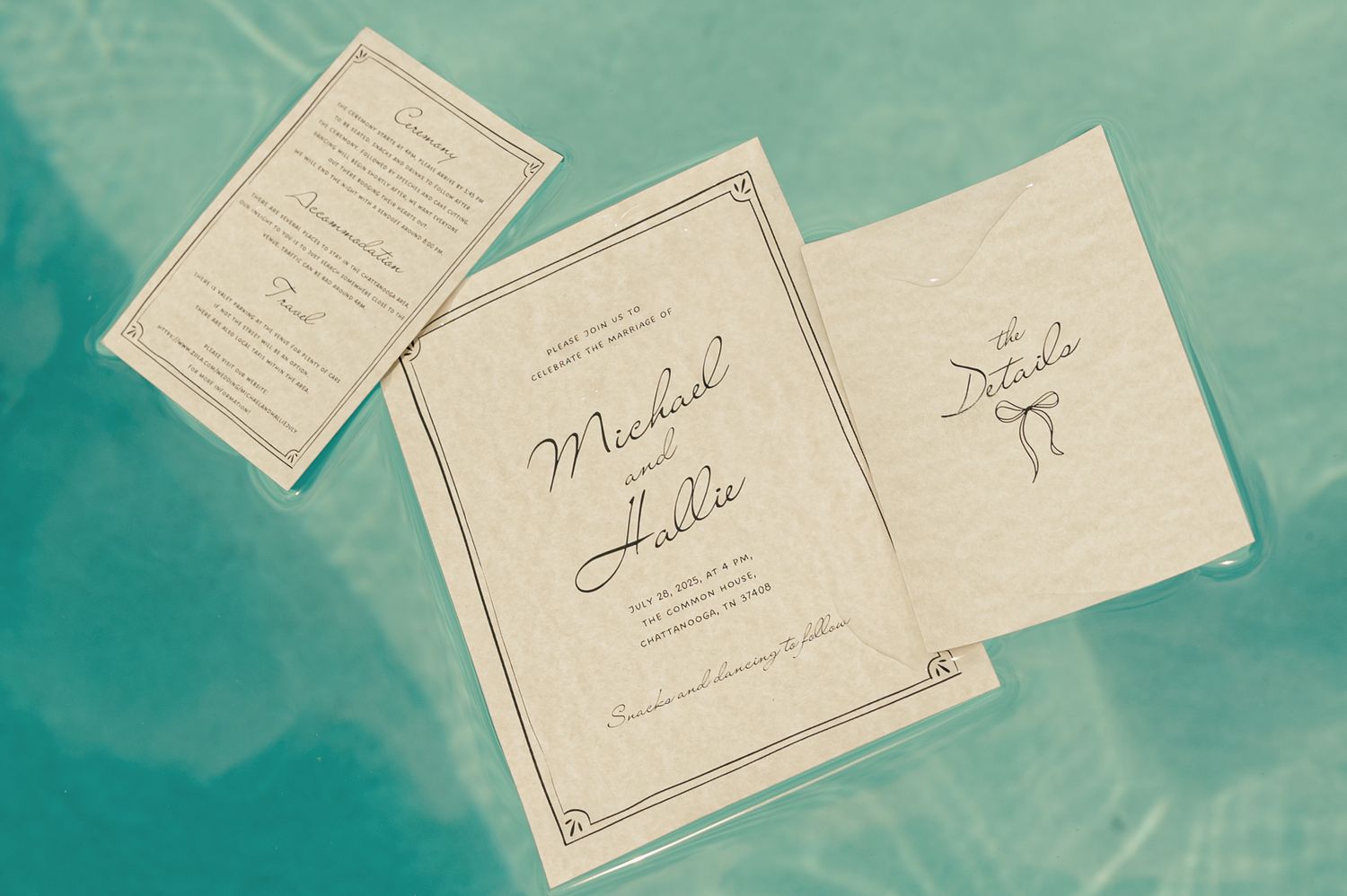 Wedding invitation suite for Michael and Hallie floating on a teal surface.