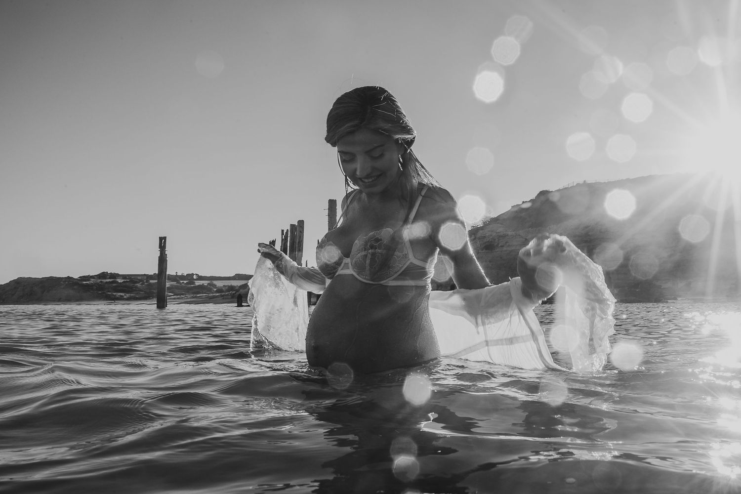 Pregnant lady frollicking in the ocean and splashing.  Adelaide maternity lifestyle photographer - Raised by Water Photography