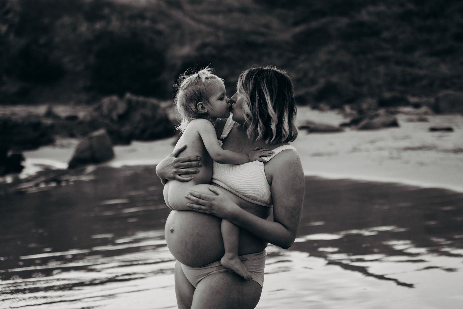 Mum cradling baby by the ocean during golden hour – South Australian beach photography