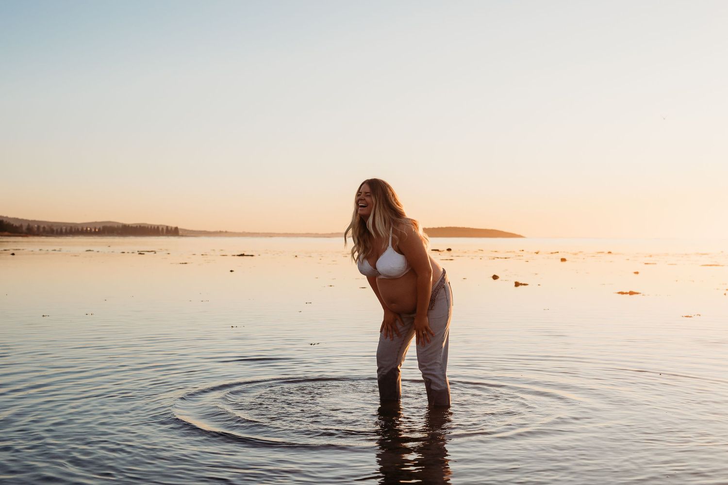 Pregnant lady standing in the calm ocean.  Adelaide maternity photographer