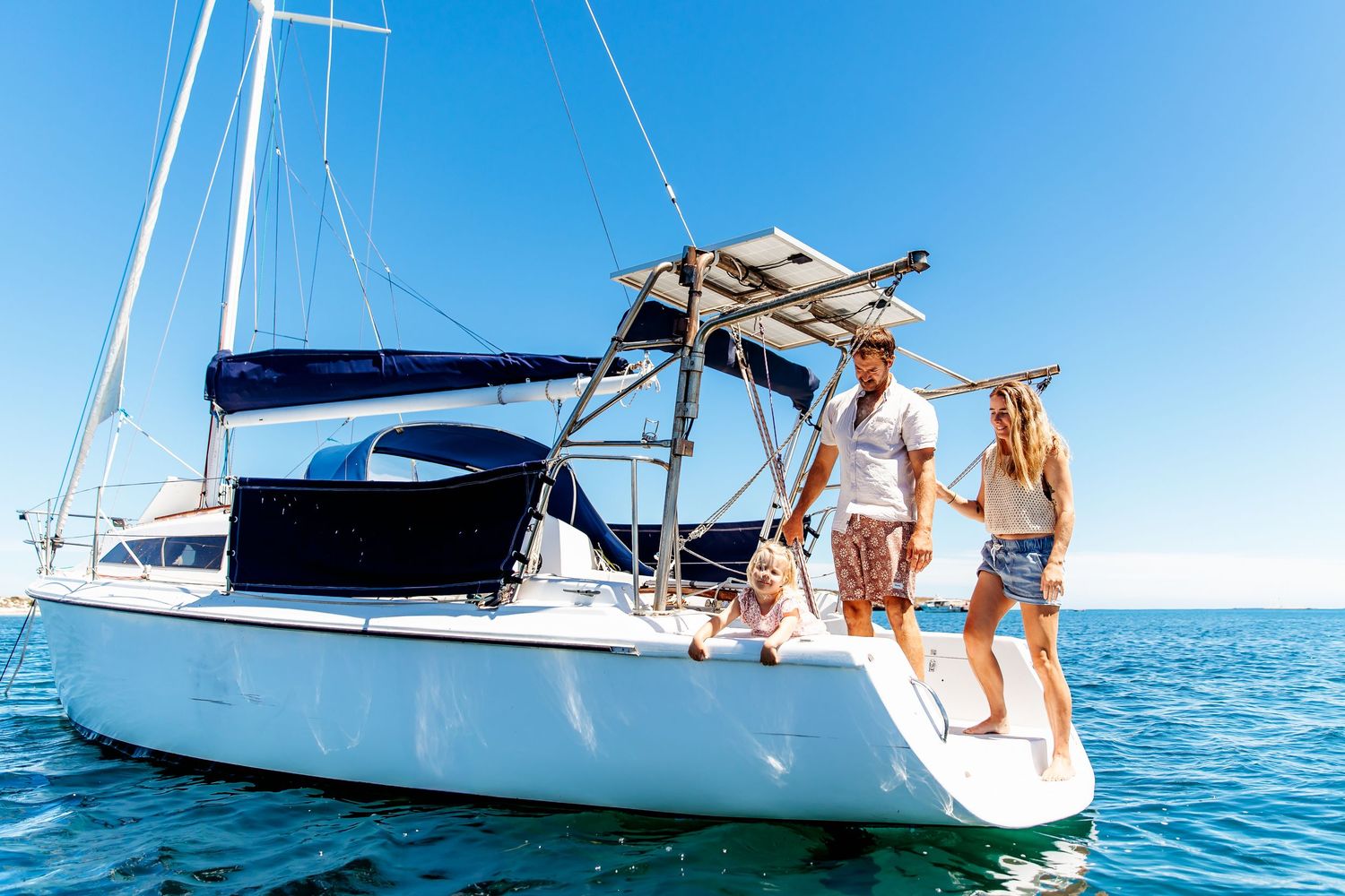 Family enjoying time together on a boat in the middle of the ocean – Raised by Water Photography, Adelaide