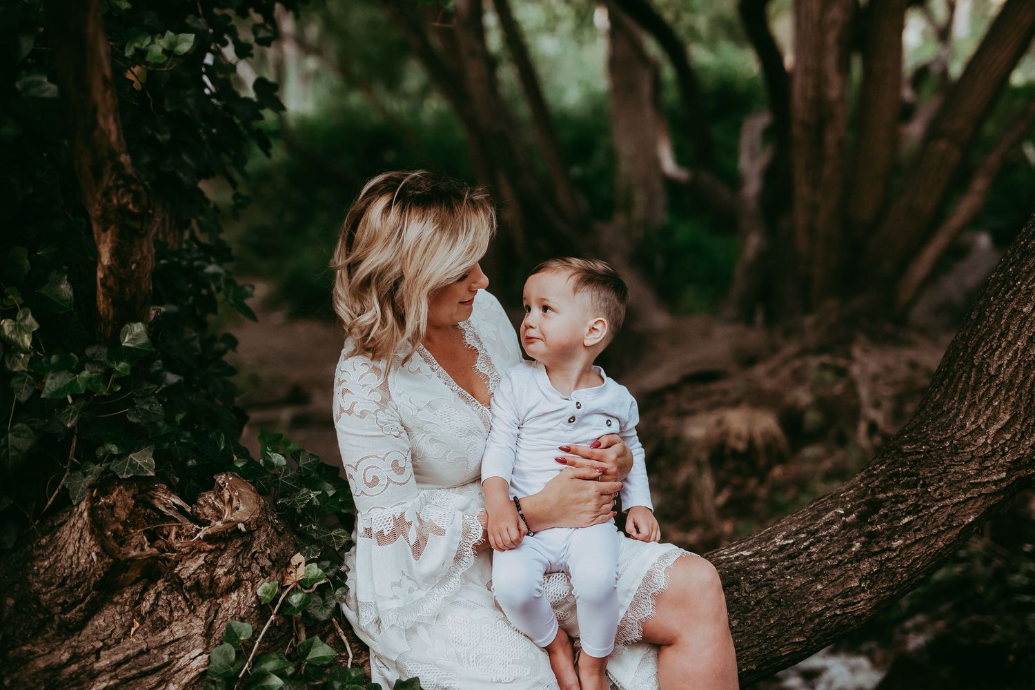 Mum and child sitting together in a tree, sharing a loving gaze – Raised by Water Photography, Adelaide