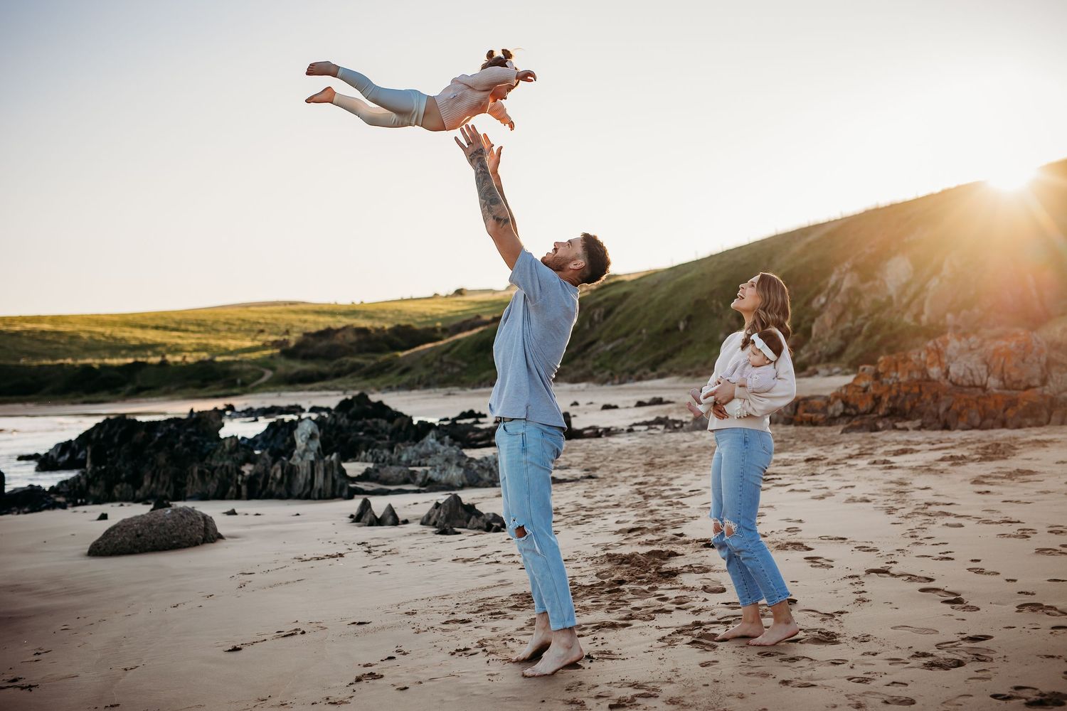 Candid lifestyle beach photo of parents and two children, joyful and carefree session in Adelaide, South Australia