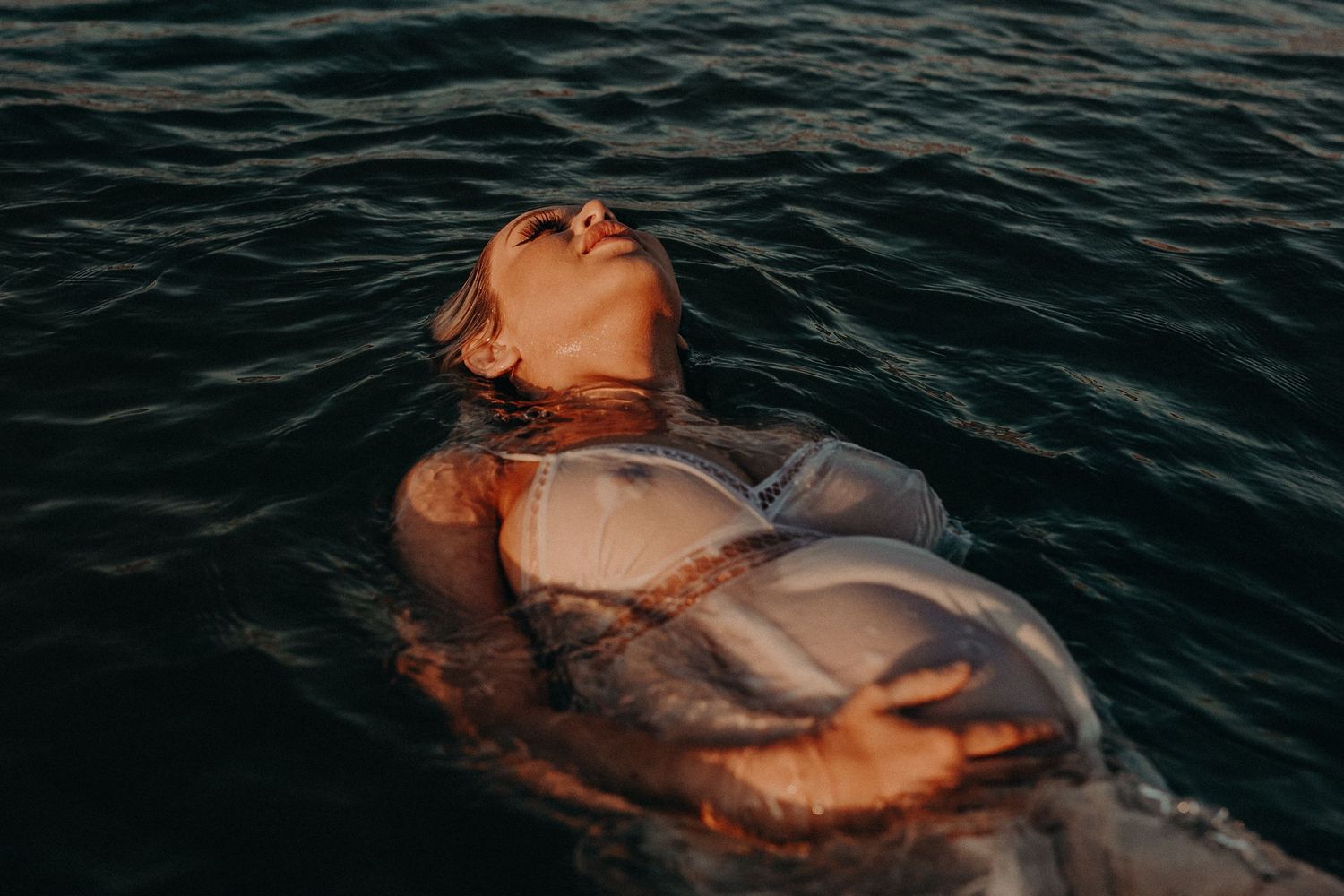 Woman floating calmly on her back in the ocean – Raised by Water Photography Adelaide portrait and underwater photographer
