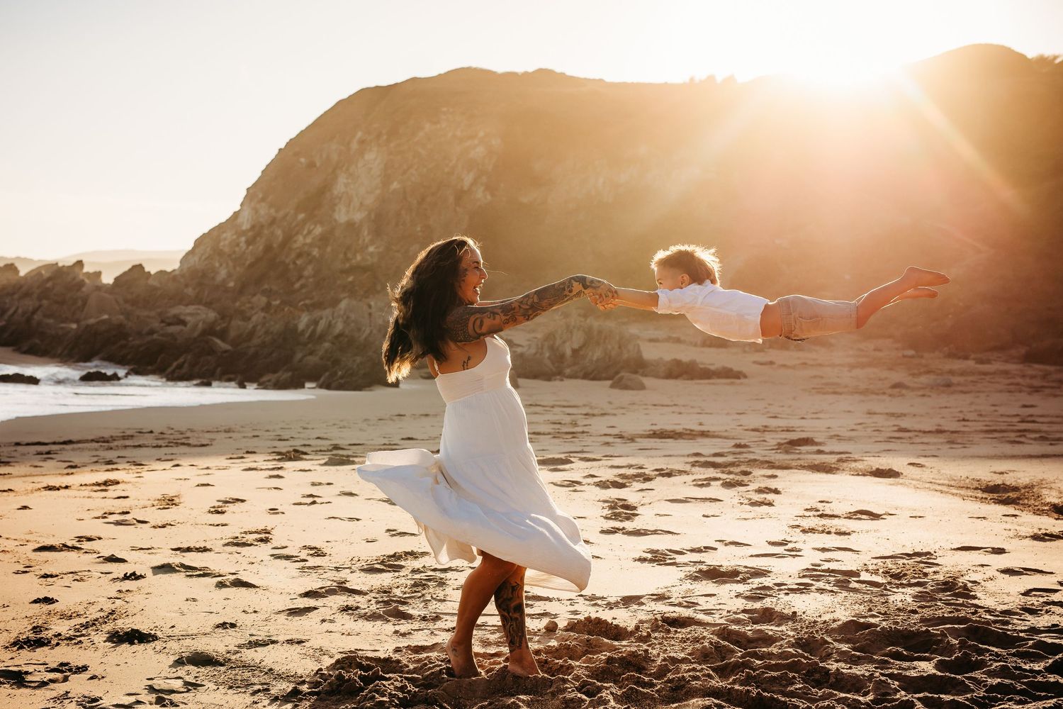 Mum spinning child around joyfully in golden sunlight – Raised by Water Photography, Adelaide
