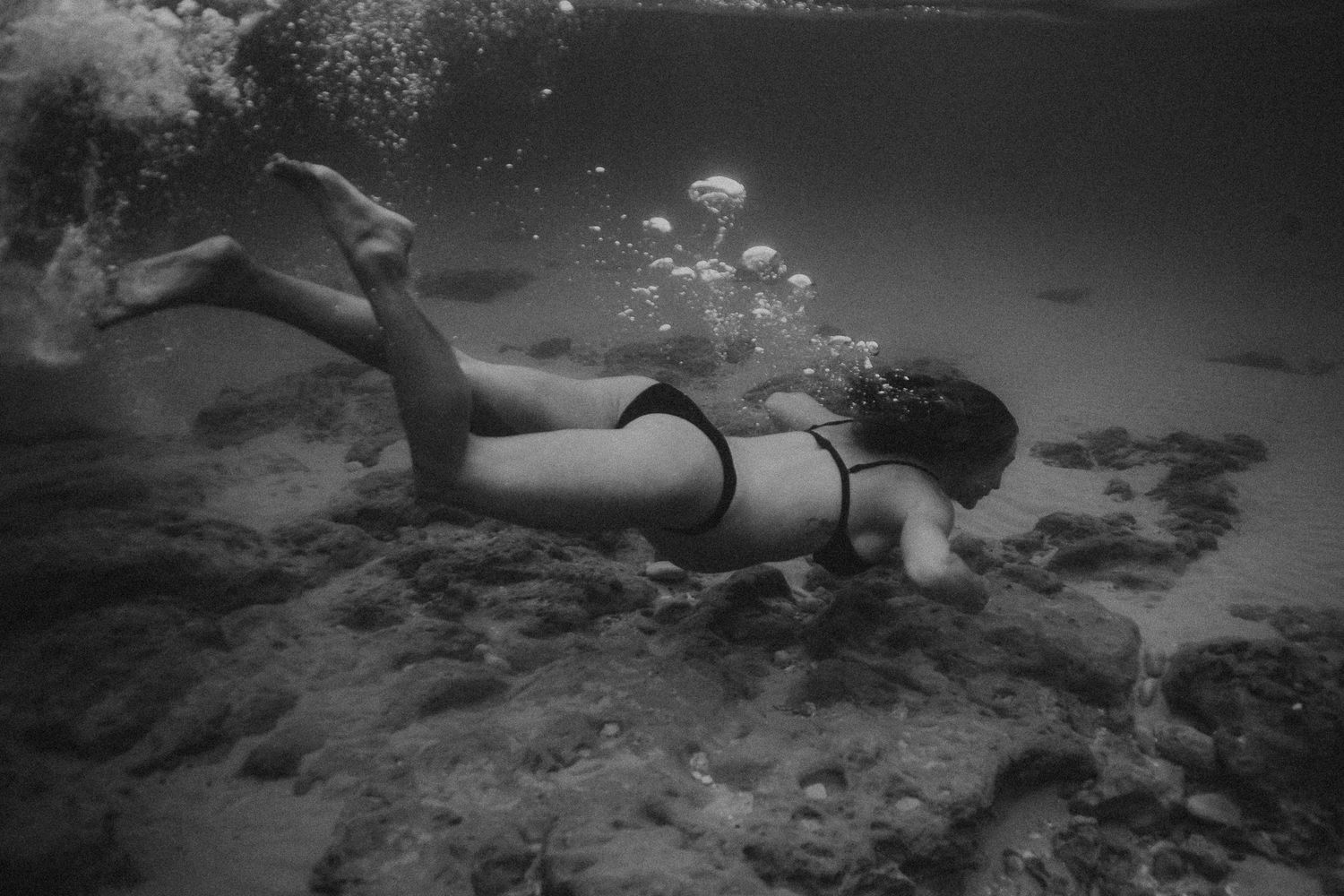 Woman swimming gracefully underwater in clear ocean near Adelaide – Raised by Water Photography
