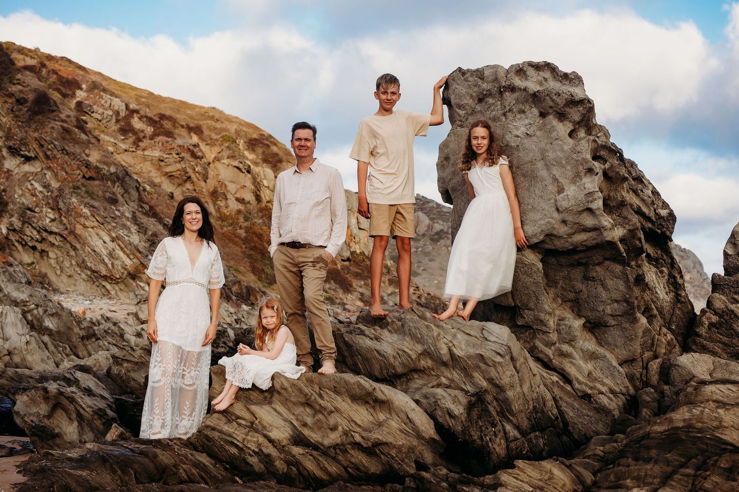 Family standing on a rock at the beach - Adelaide family photographer - Raised by Water Photography