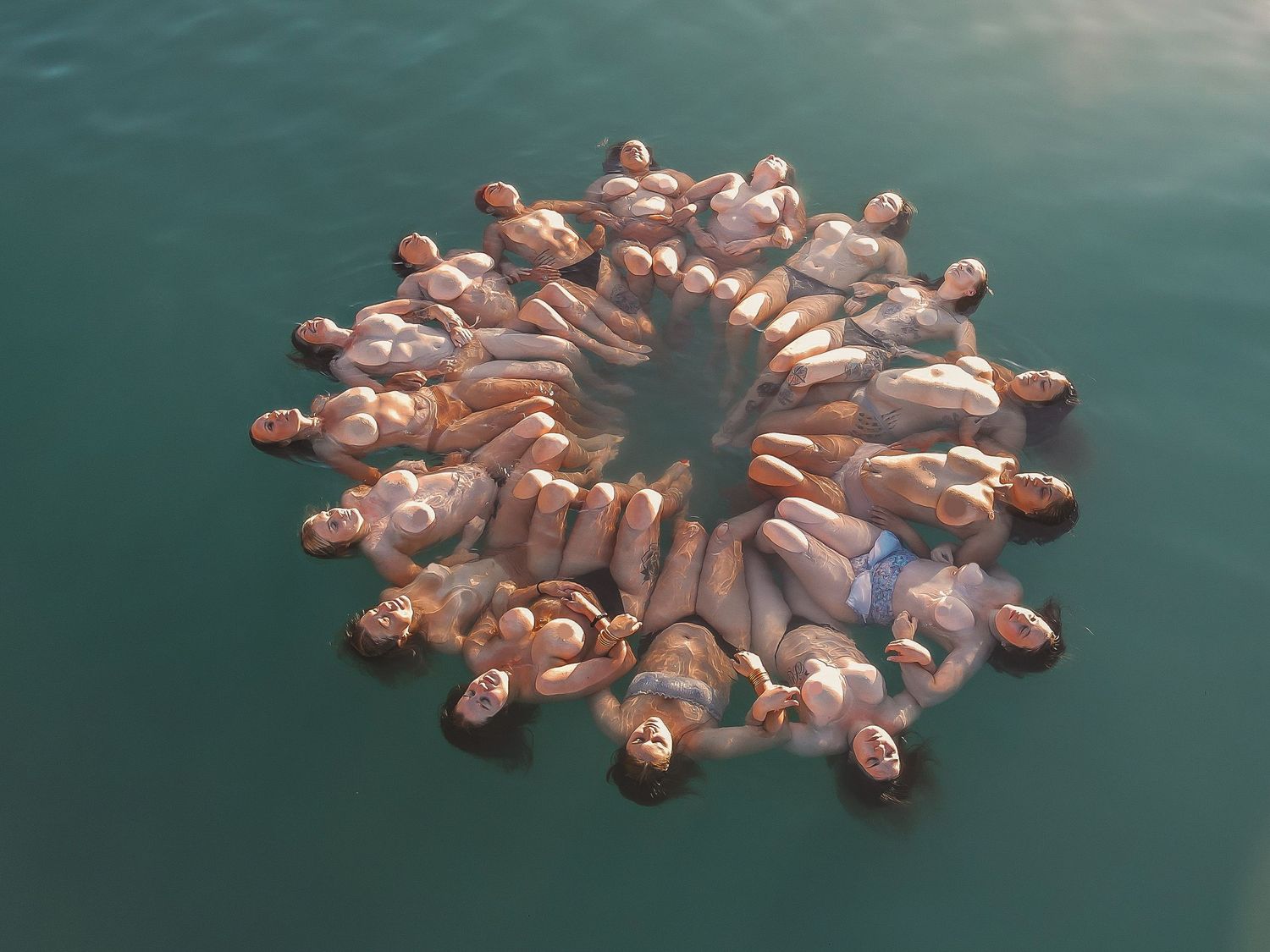 Serene image of a group of women enjoying calm ocean waters – Raised by Water Photography
