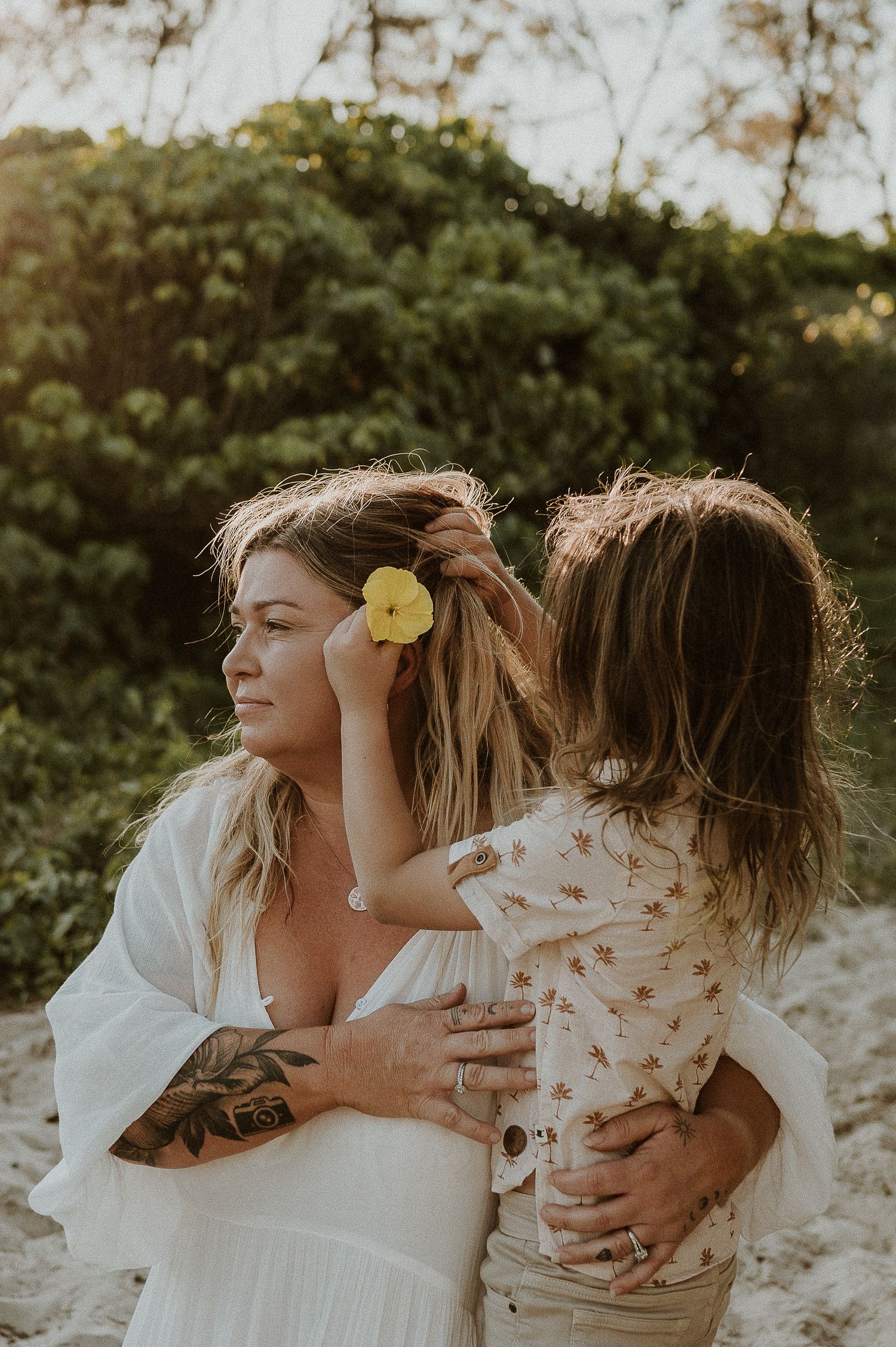 Loving mother and child captured on beach near Adelaide, South Australia, boy placing flower in hair