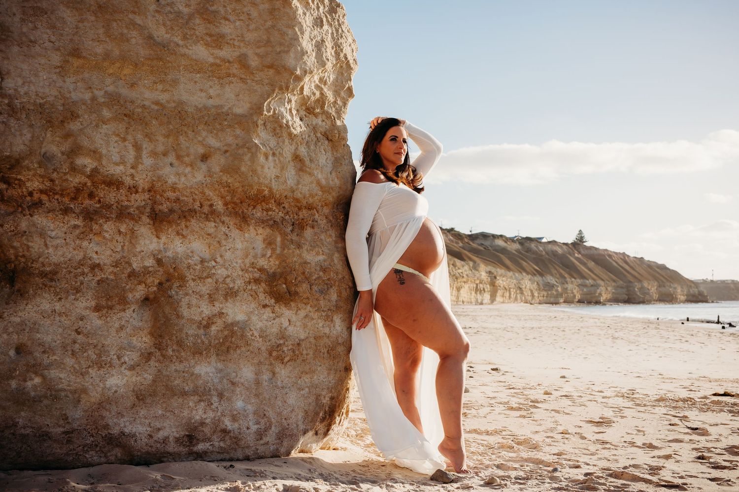 Pregnant woman standing against rugged cliffside – Adelaide maternity photography