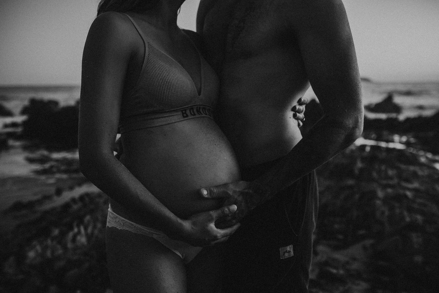 Close-up of pregnant belly with mum and partner’s hands gently resting – Adelaide maternity photography