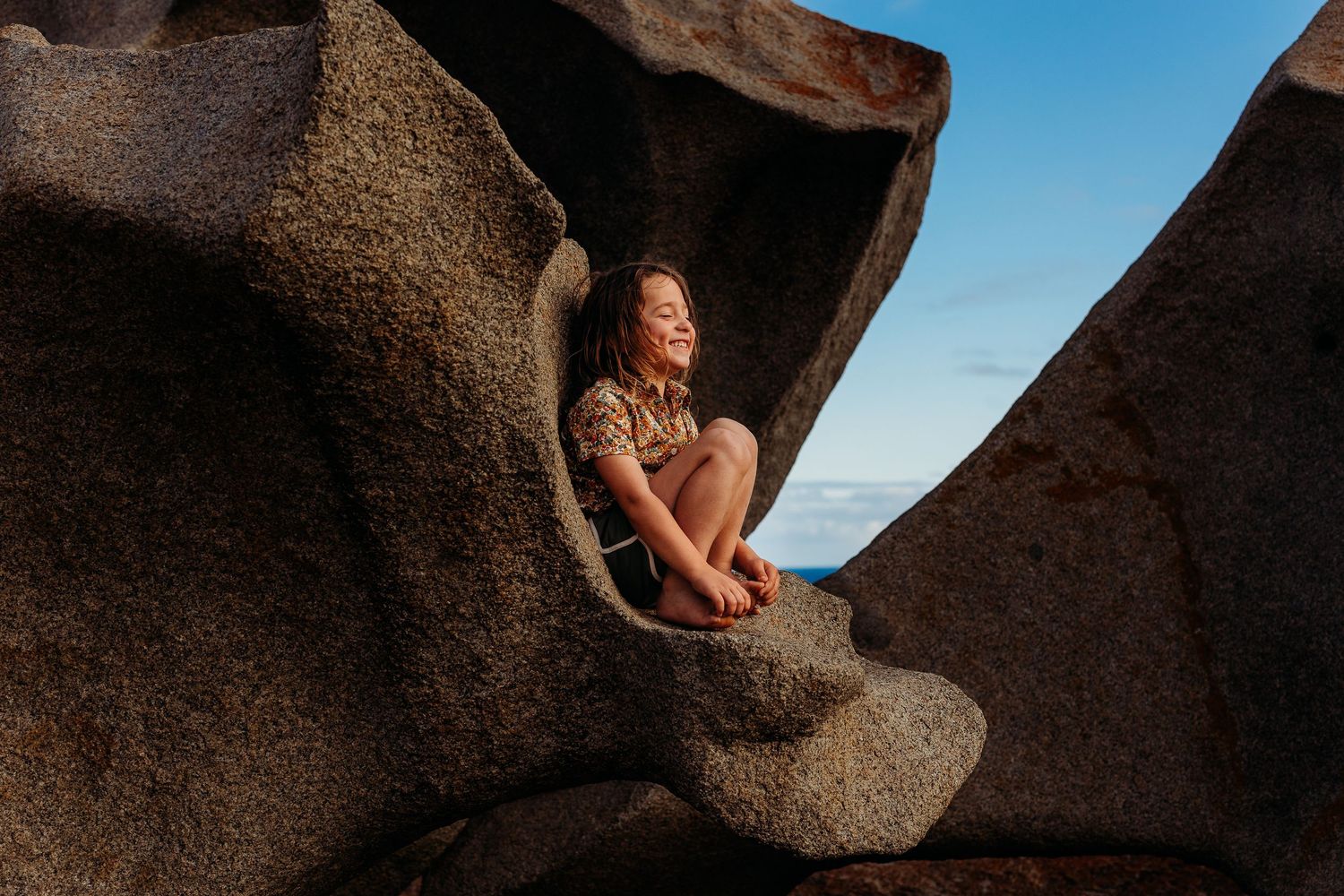 Boys sitting in a rock smiling in Adelaide, South Australia - Raised by Water Photography