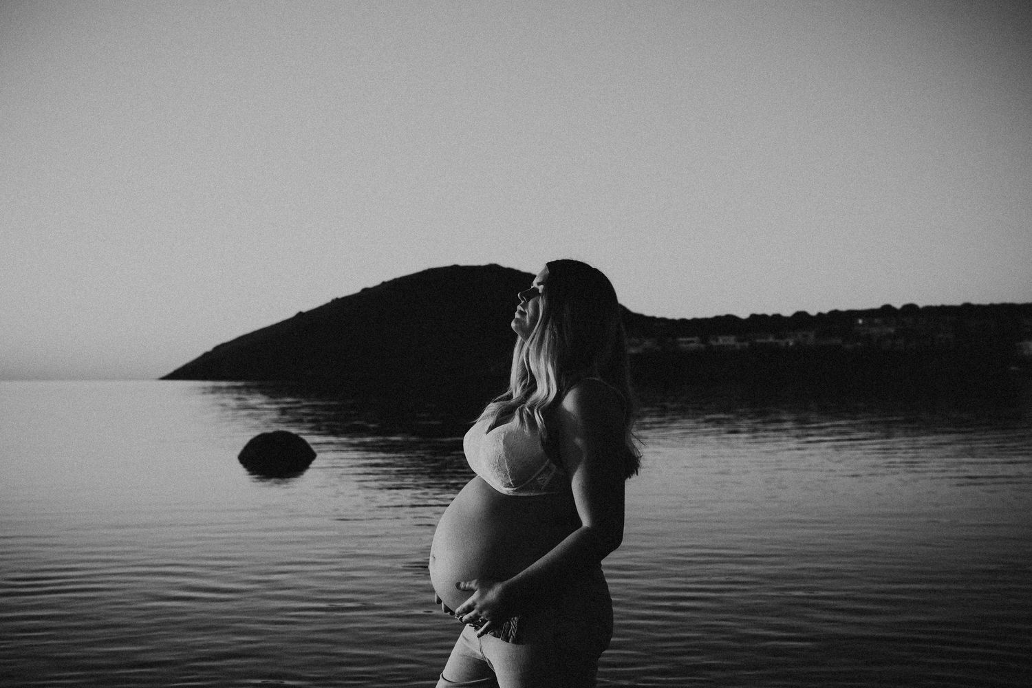 Golden hour photo of pregnant mother with hands cradling belly – Fleurieu Peninsula