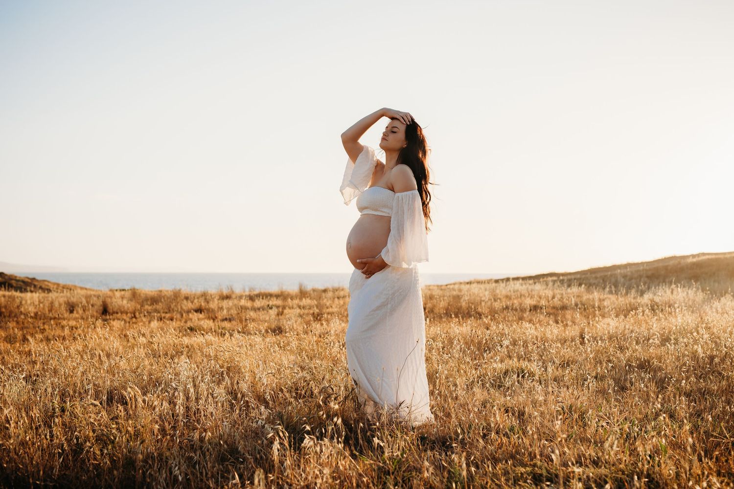 Pregnant lady in golden field.  Adelaide maternity and family photographer - Raised by Water Photography
