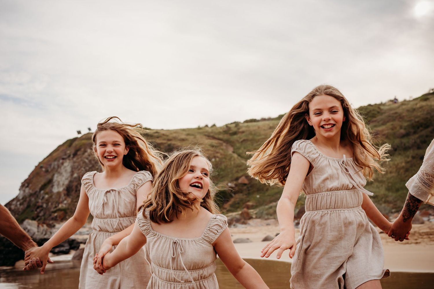 Children running and laughing on beach.  Adelaide family and lifestyle photographer.