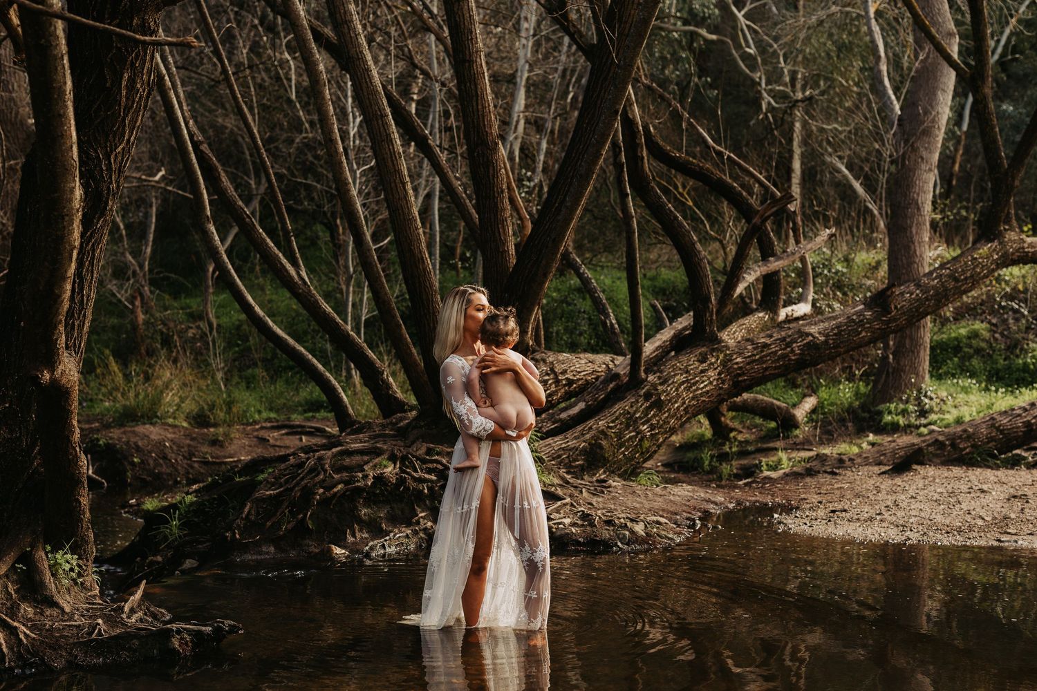 Mum holding her baby in a creek in Adelaide, South Australia