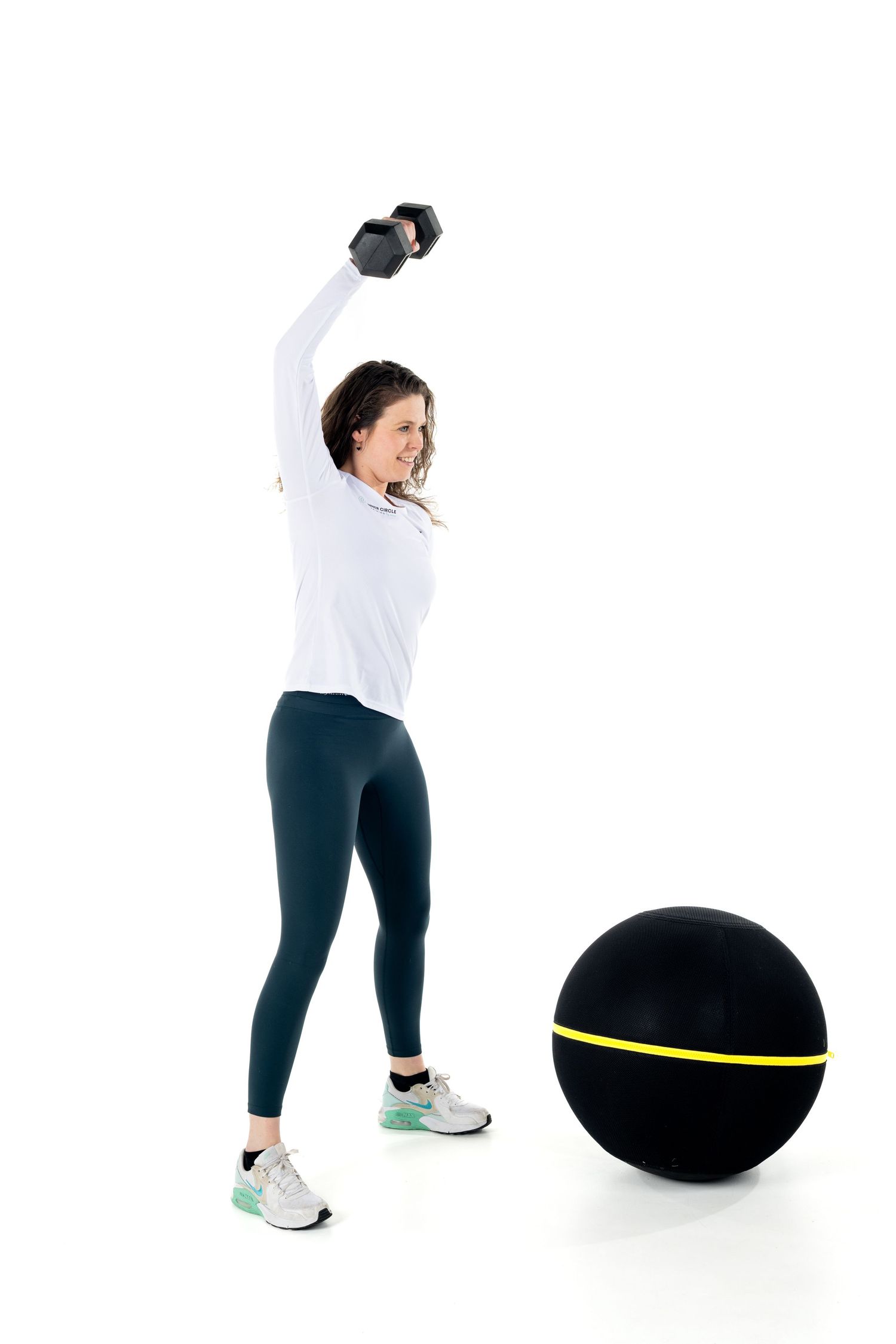 Woman in workout attire demonstrating exercise sequence with black balance ball and yellow accent.