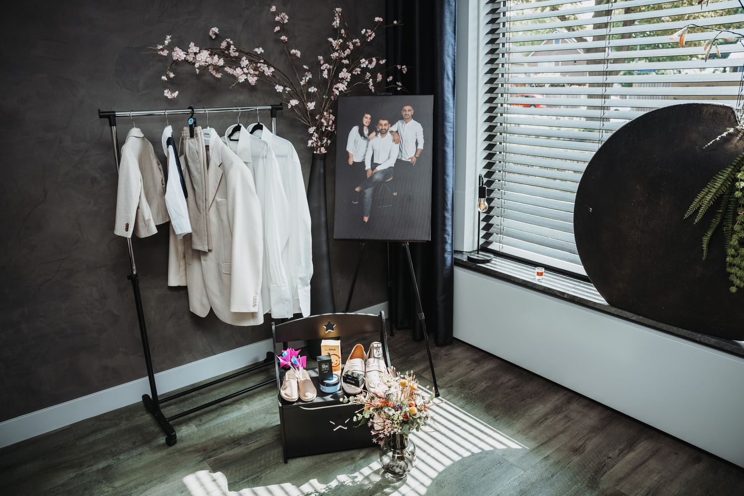 Modern dressing room with black-framed mirrors and natural light streaming through windows.