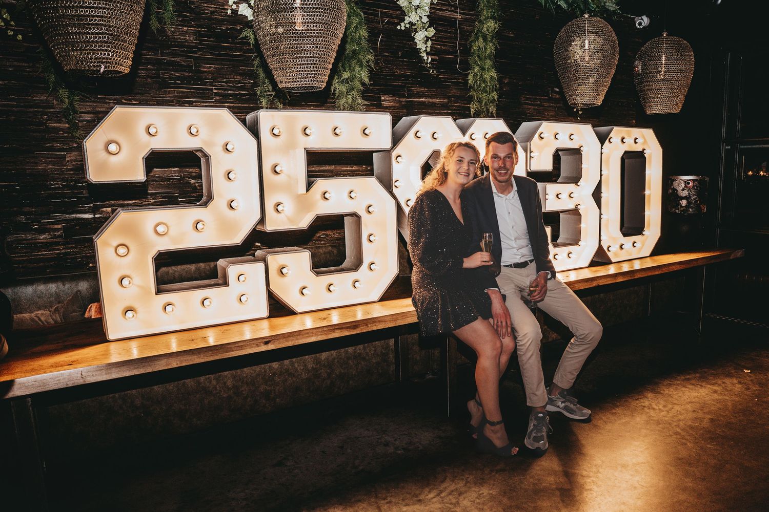 Illuminated marquee letter sign display at night against brick wall.