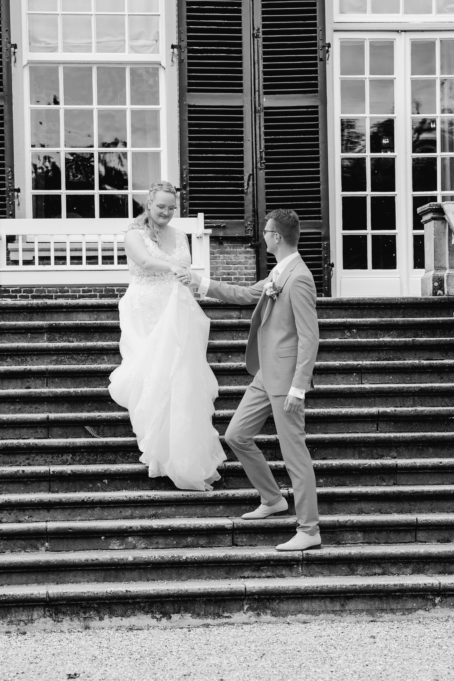 A sequence of black and white photos showing a couple descending stone steps.
