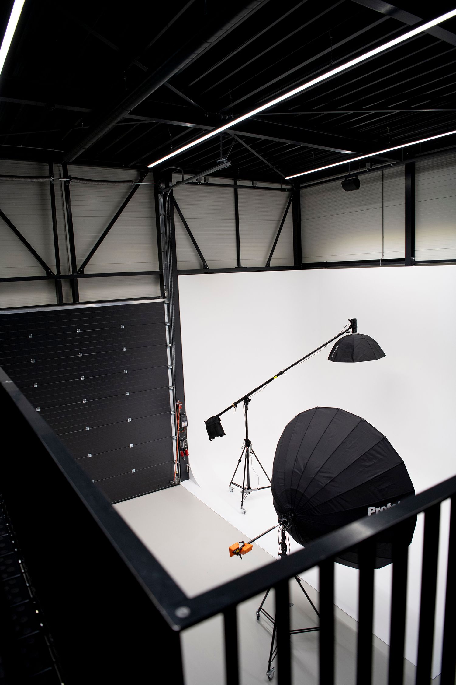 Professional photography studio setup with lighting equipment and white backdrop.