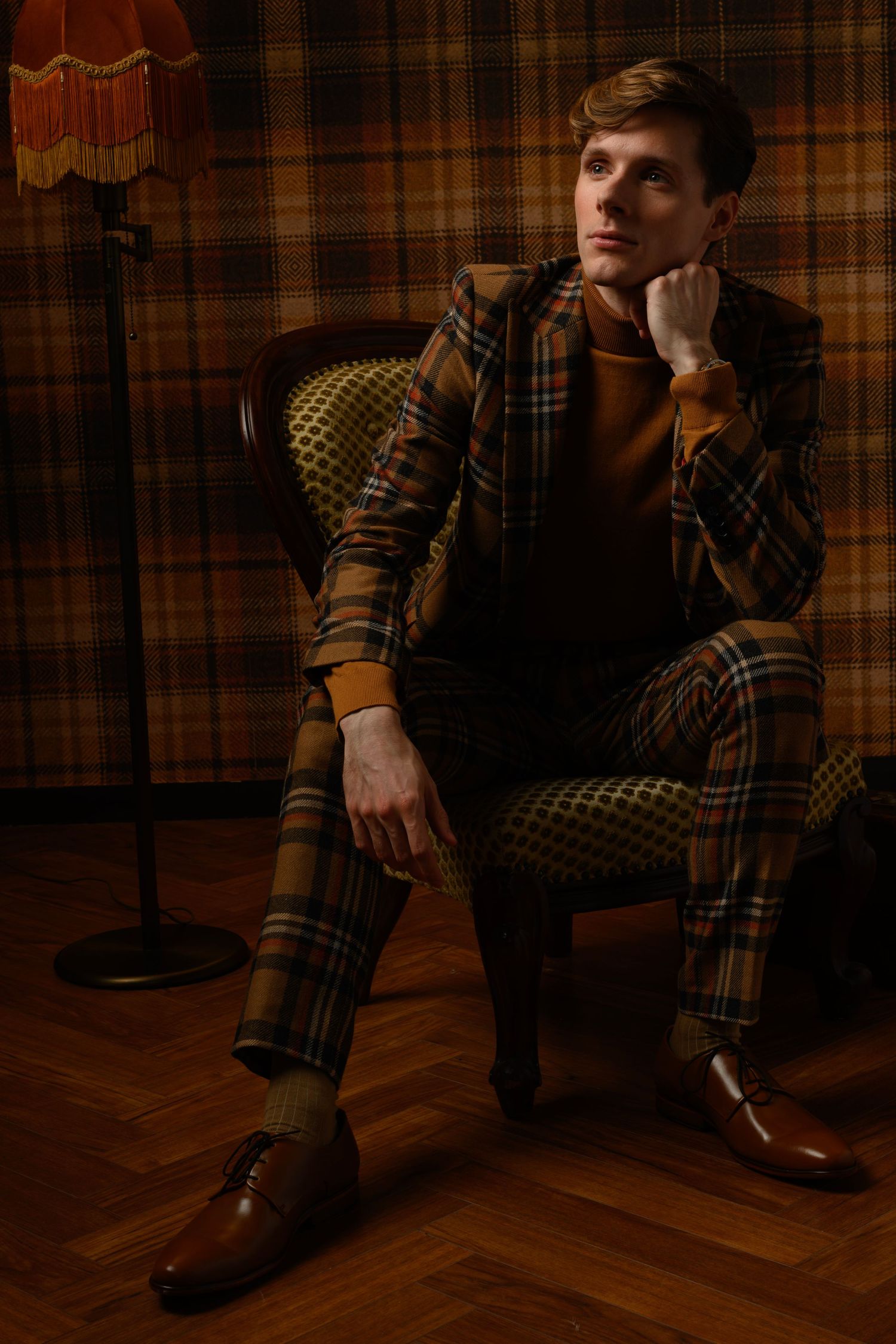 Moody portrait series against plaid wallpaper showing different poses.