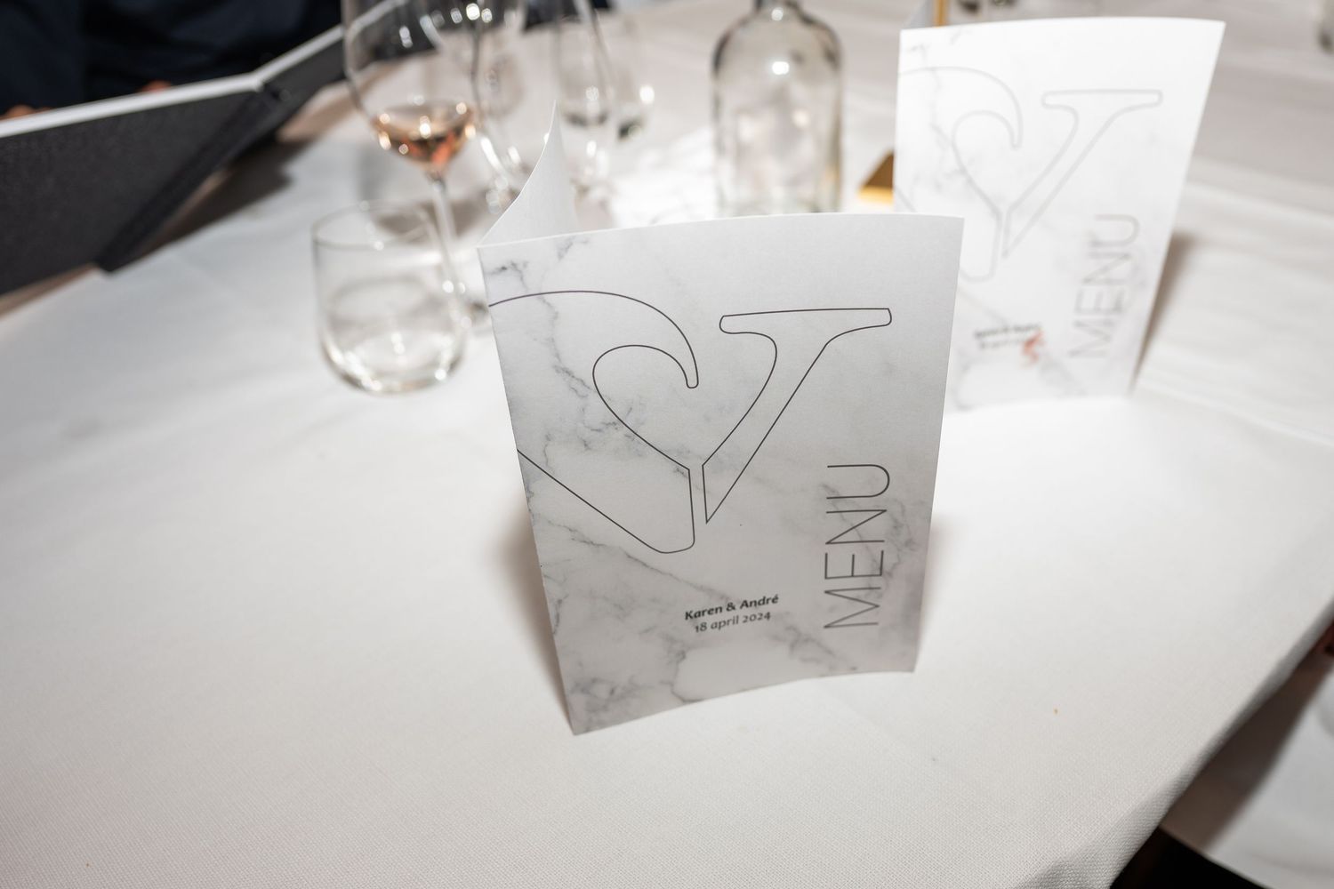 Simple line drawings and sketches on white paper with glasses and table settings visible.