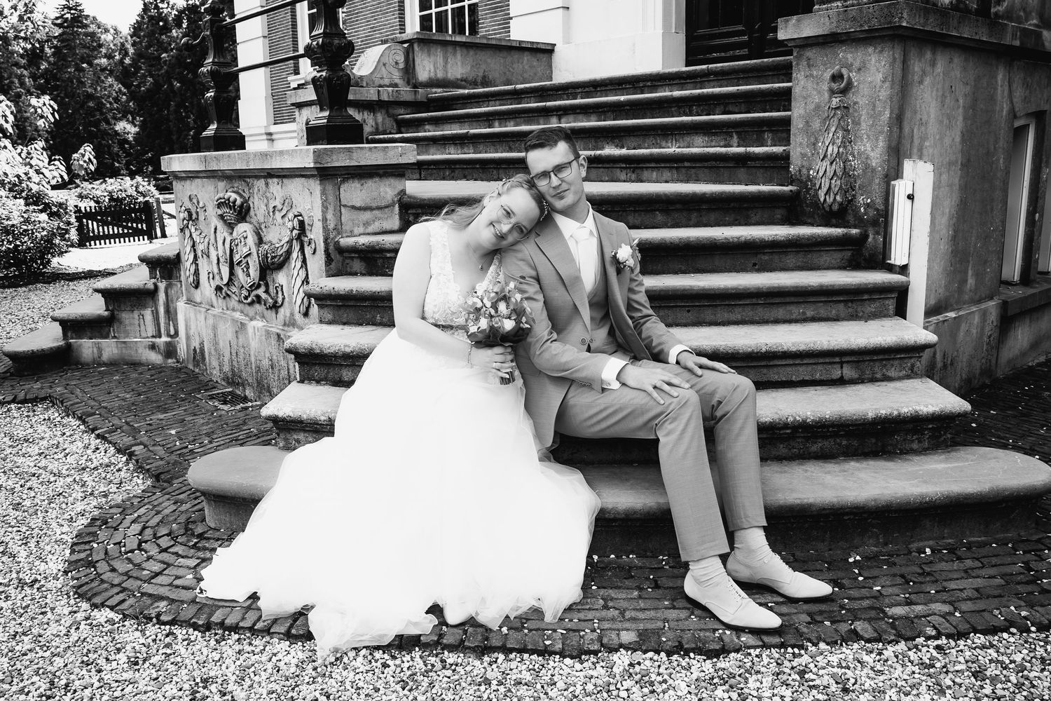 A black and white photo sequence of a couple sitting on stone steps.