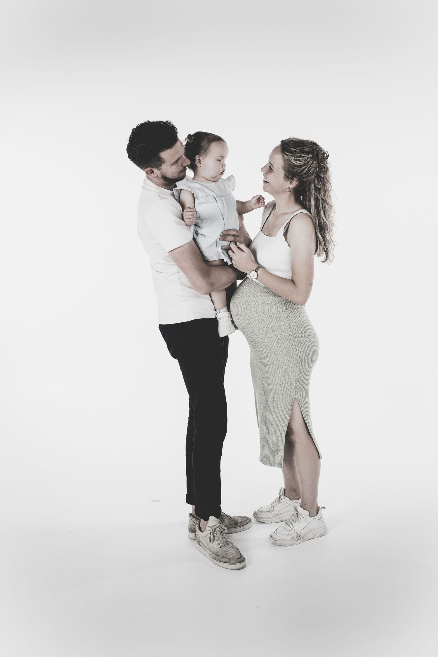 Casual portrait series showing sweet interactions in white studio setting.