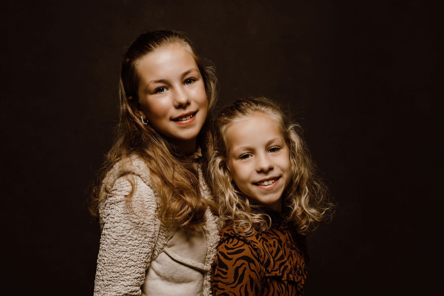 Close-up portrait series against dark background showing warm expressions.