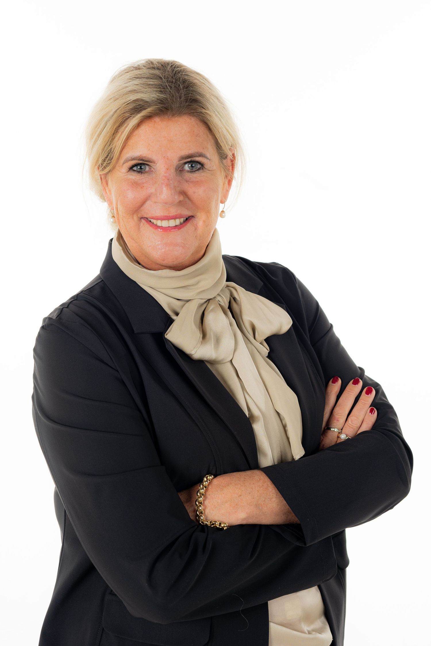 Business portrait series with black blazer and cream scarf against white backdrop.