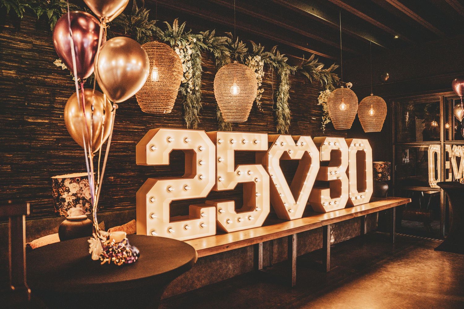 Dimly lit venue with illuminated numbers and decorative lighting creating an ambient atmosphere.