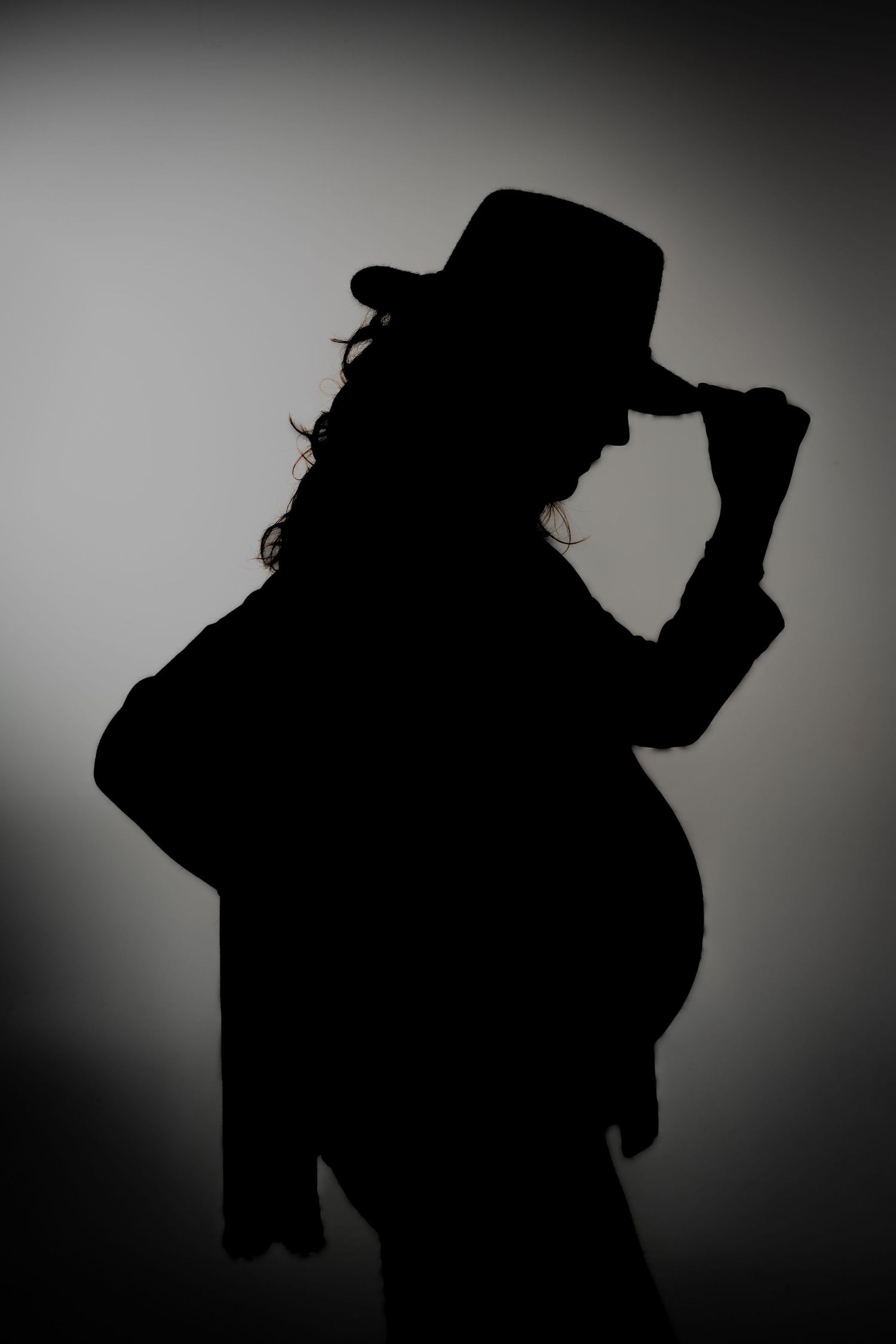 Artistic silhouette portraits against grey background showing dynamic poses.