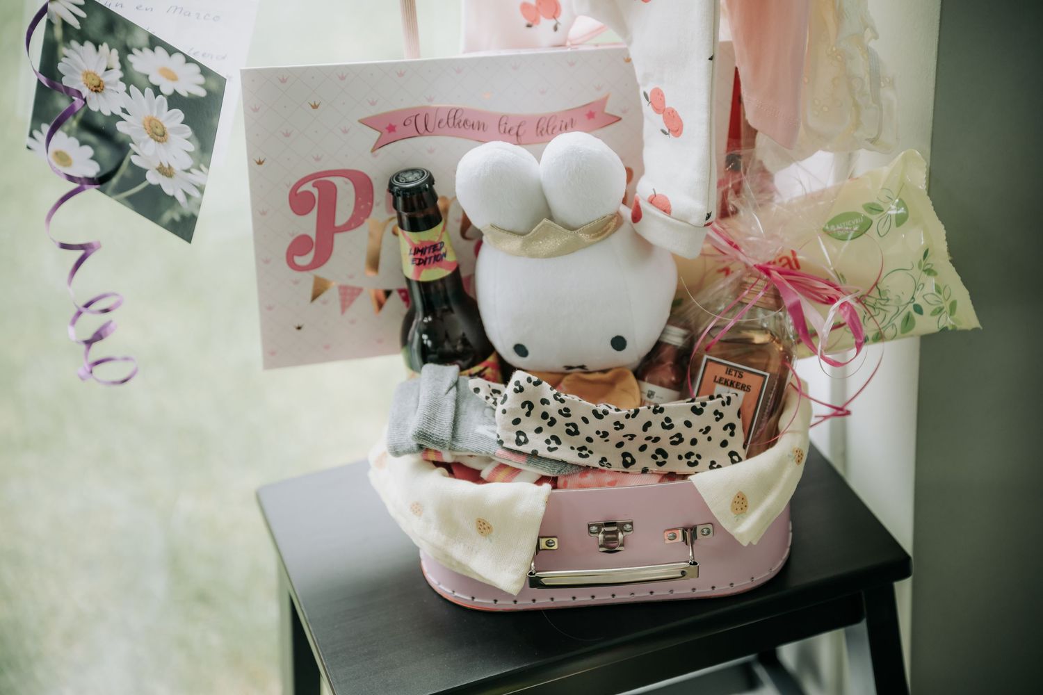 A collection of Hello Kitty themed plush toys and merchandise displayed on shelves in a retail store.