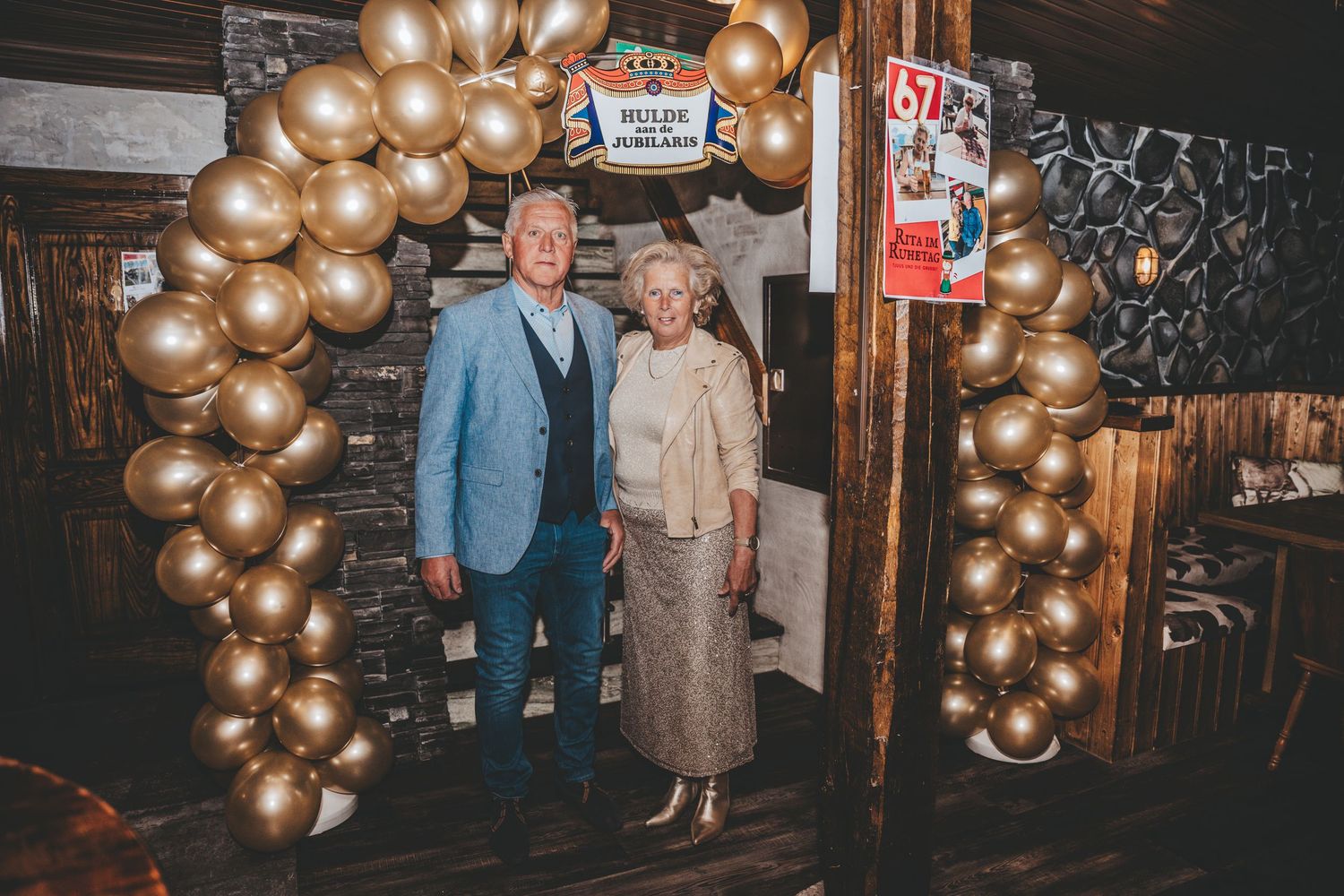 Golden balloon arch decorating a dark indoor venue for a special celebration.