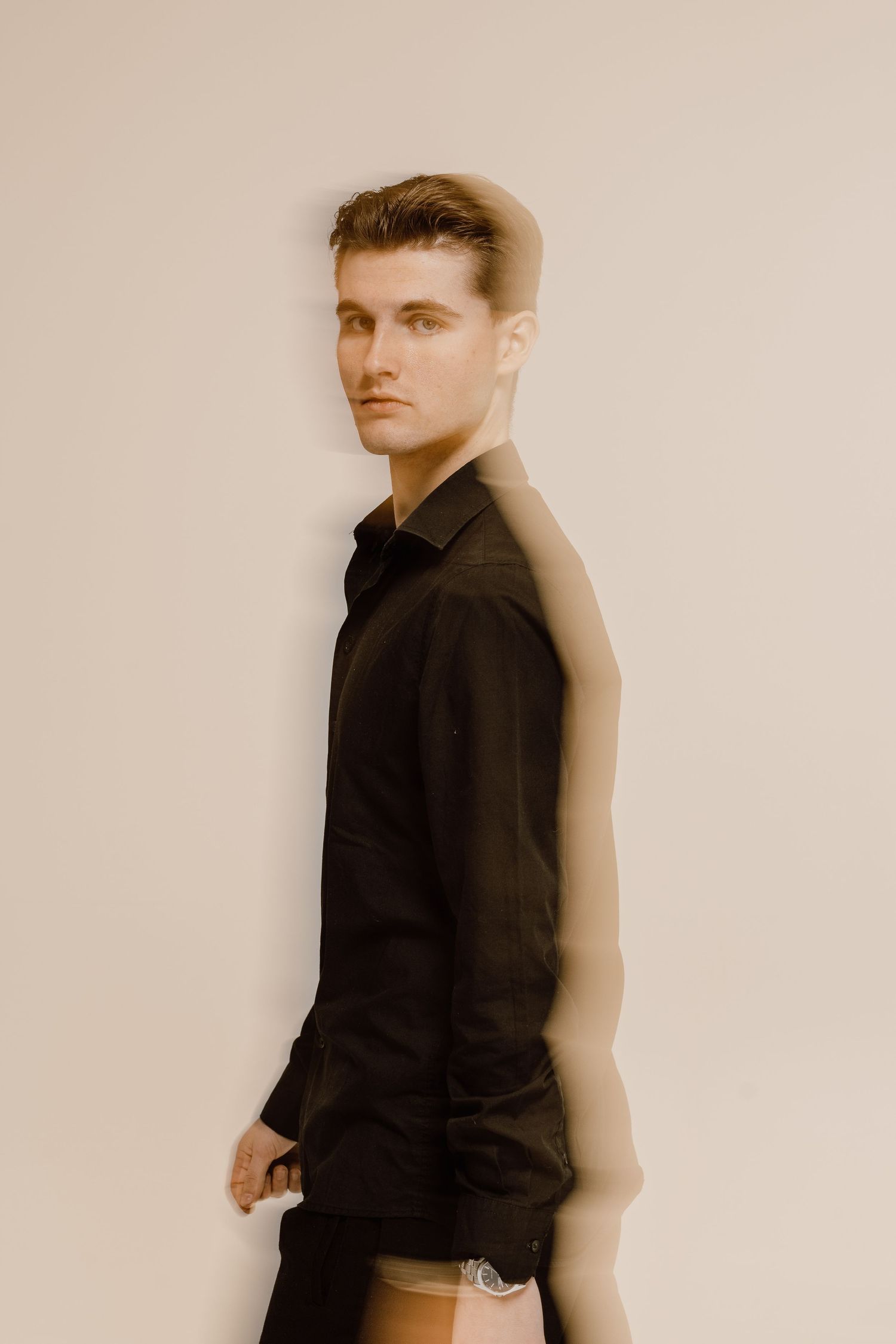 Artistic portrait series showing motion blur and dramatic lighting against a light backdrop.