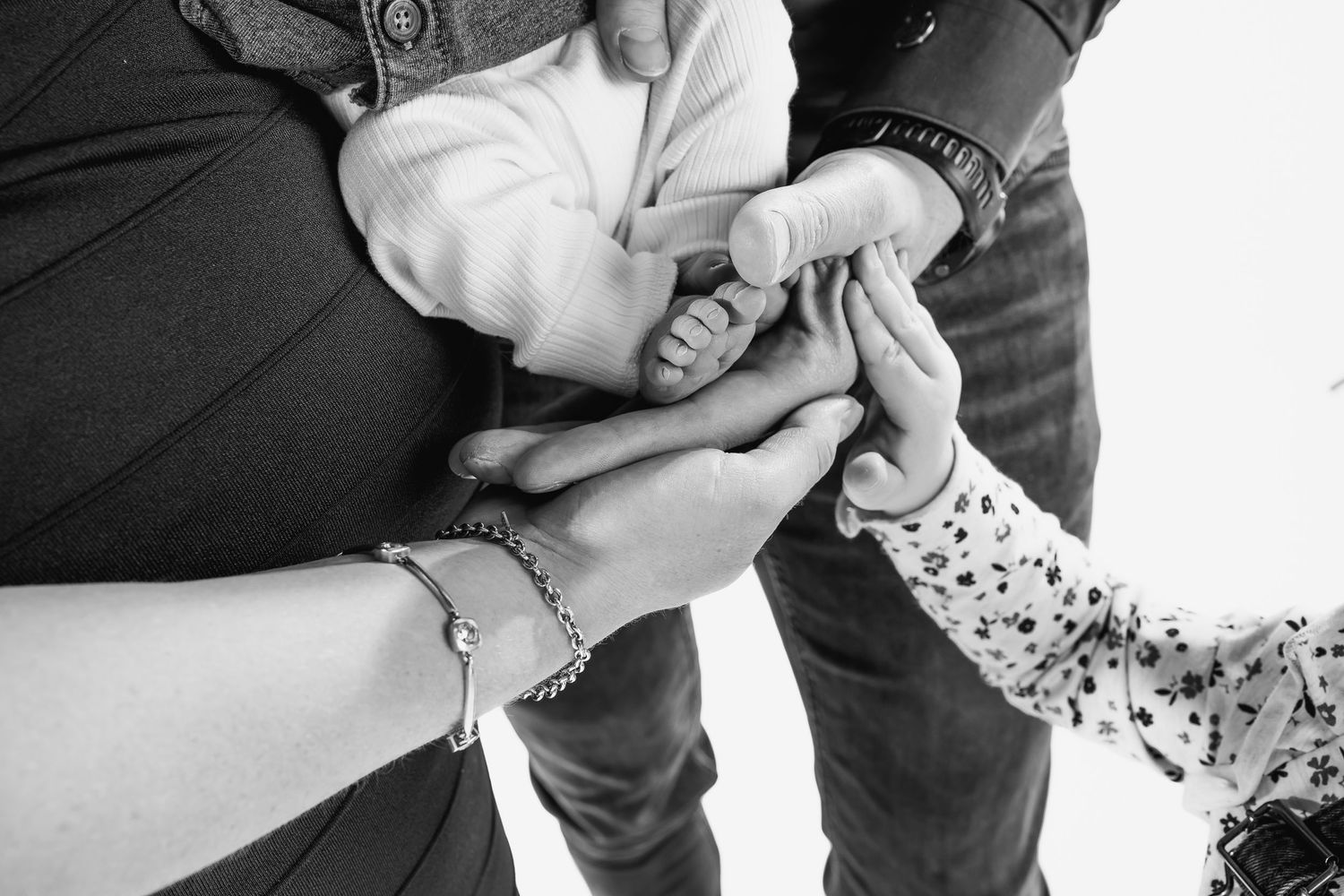 Black and white photo sequence showing hands preparing a paper roll of cigarette tobacco.