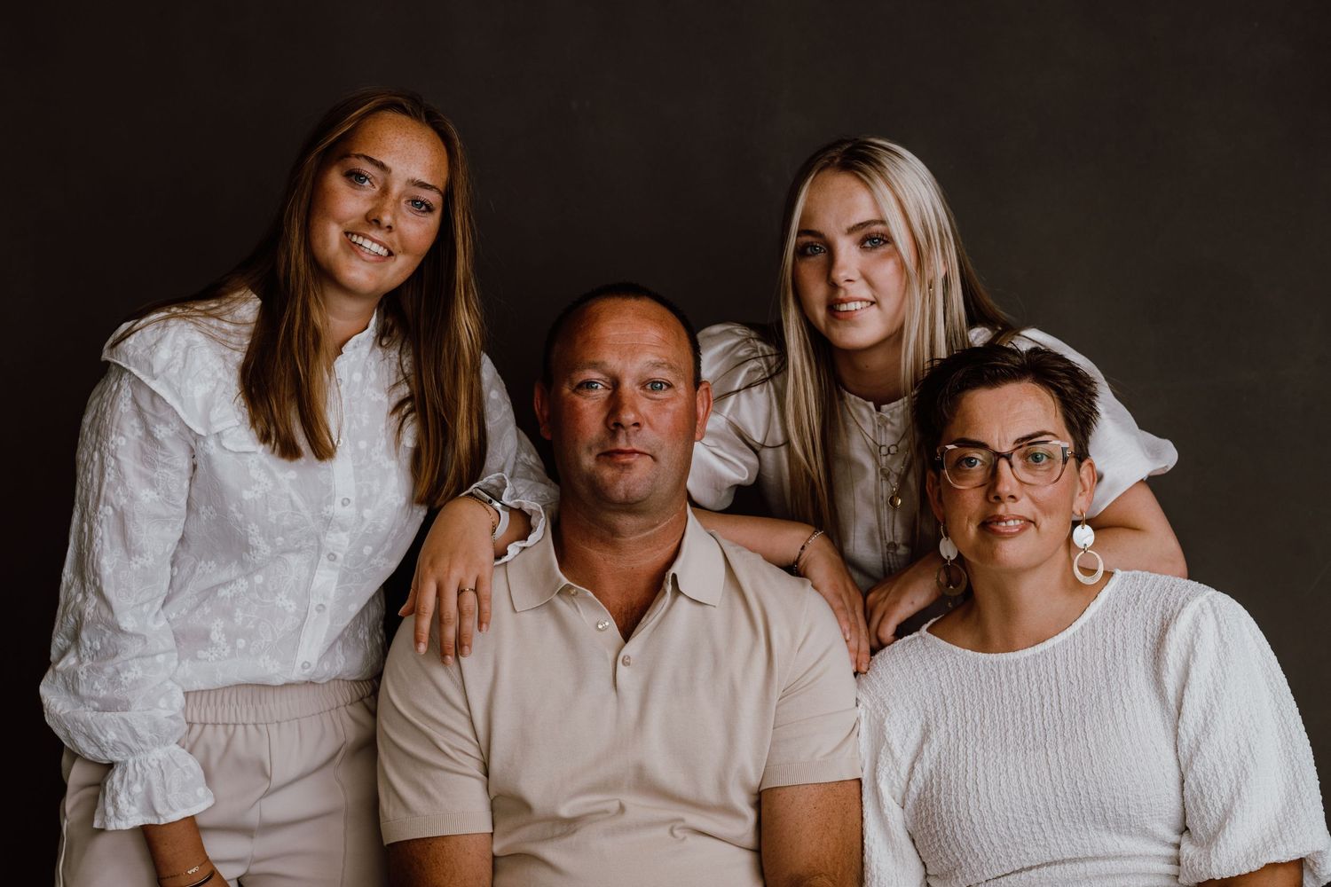 Intimate family group photos against dark dramatic background.