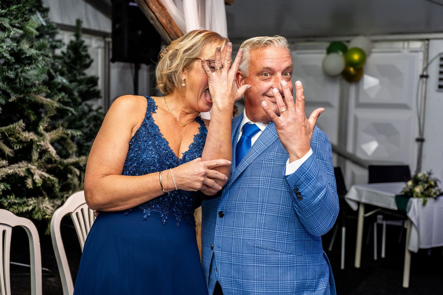 Couple in formal attire sharing intimate moment at outdoor event.