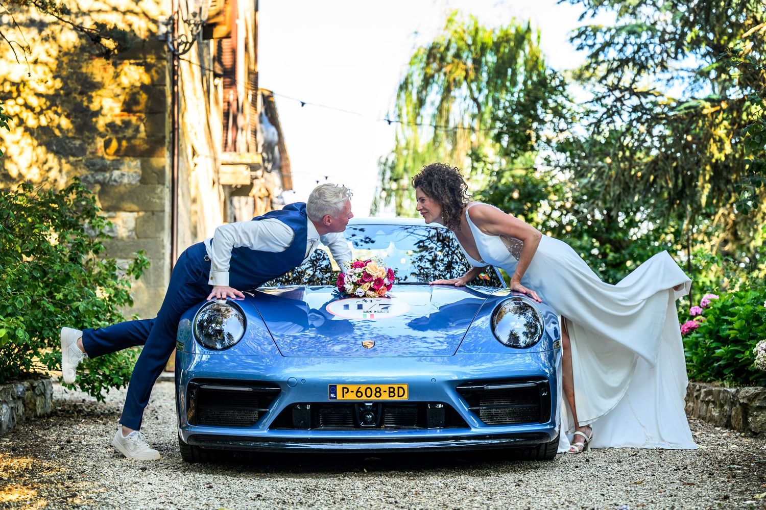 Blue sports car parked outdoors with decorative elements visible in multiple angles.