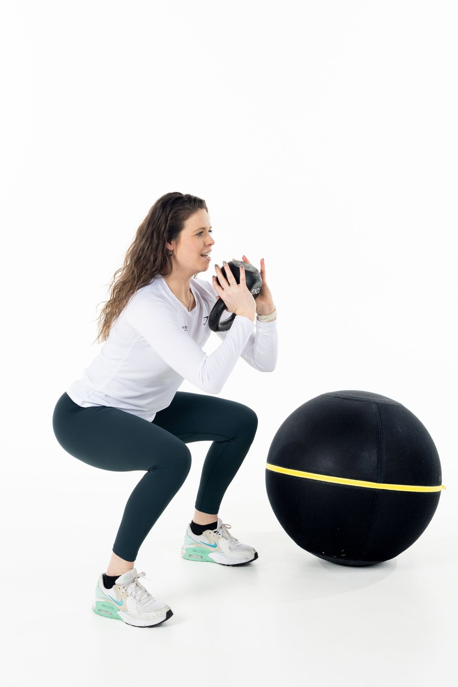 Athletic movements shown in sequence using black balance equipment on white background.