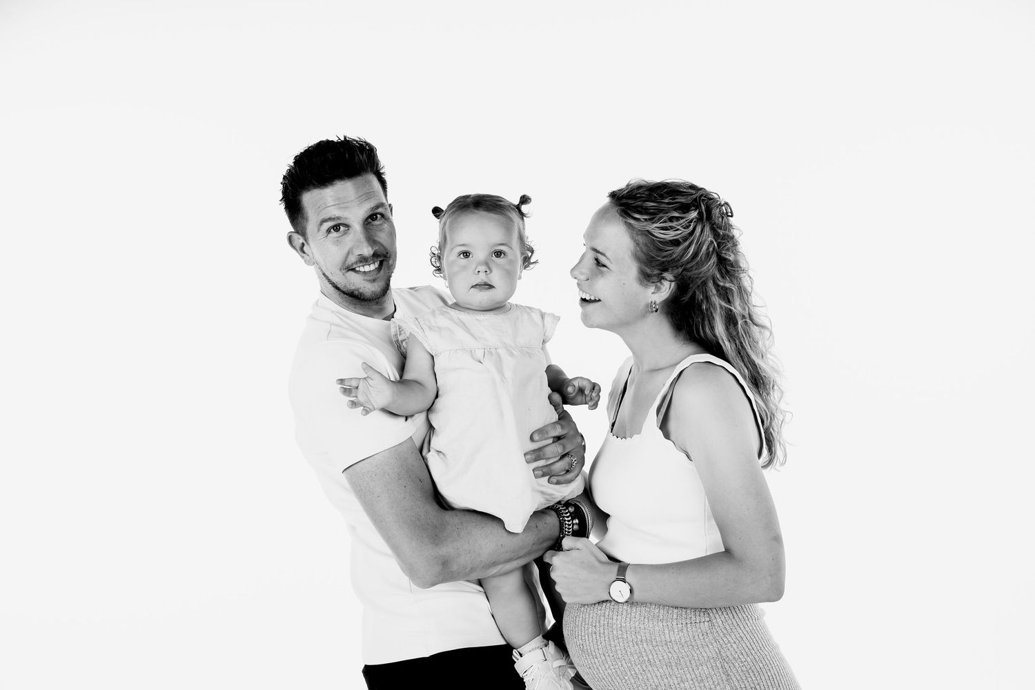 Minimalist studio portraits capturing joyful moments in black and white.