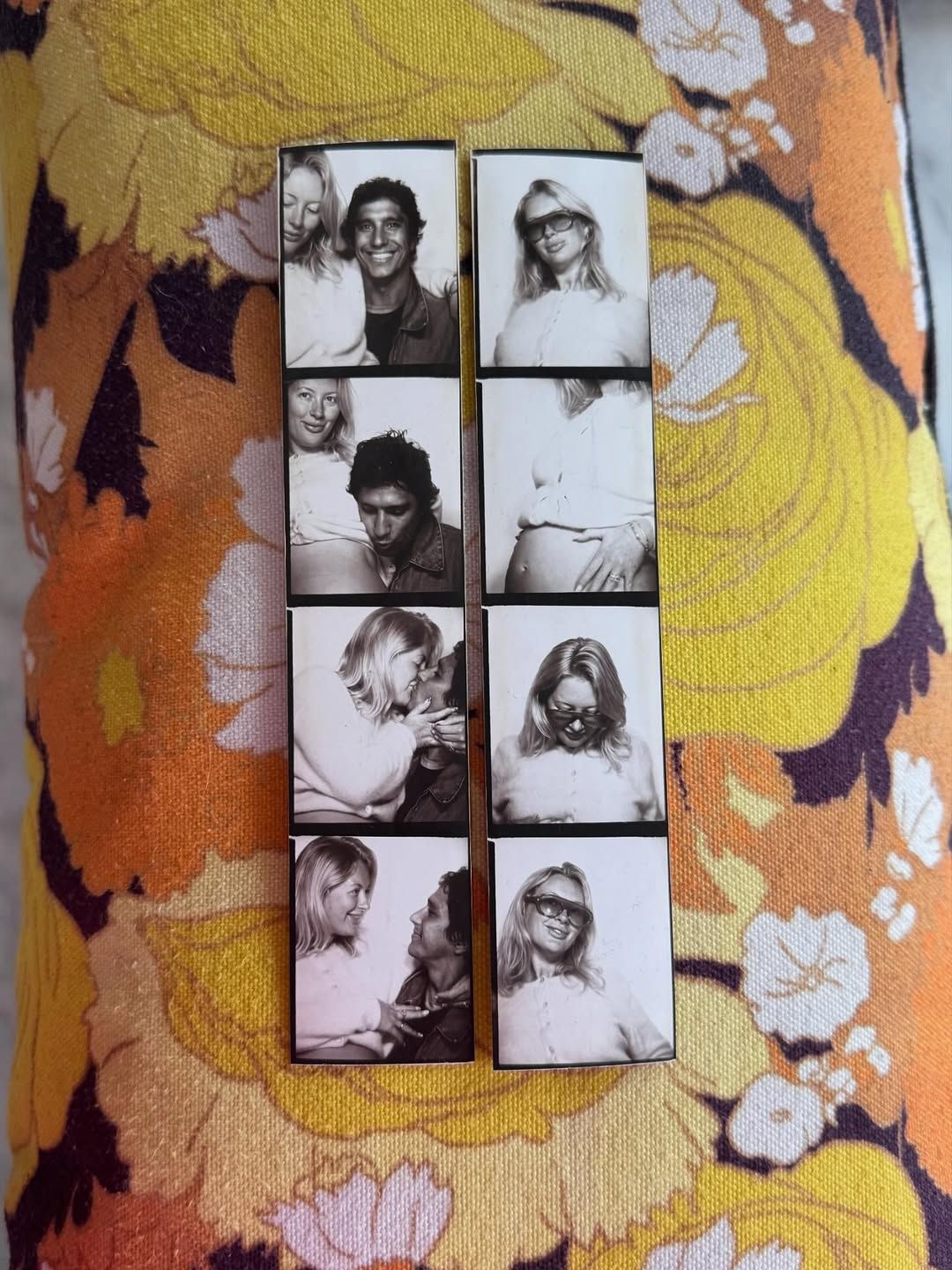 Black and white photo booth strip showing couples posing together, displayed on a colorful floral orange fabric background.