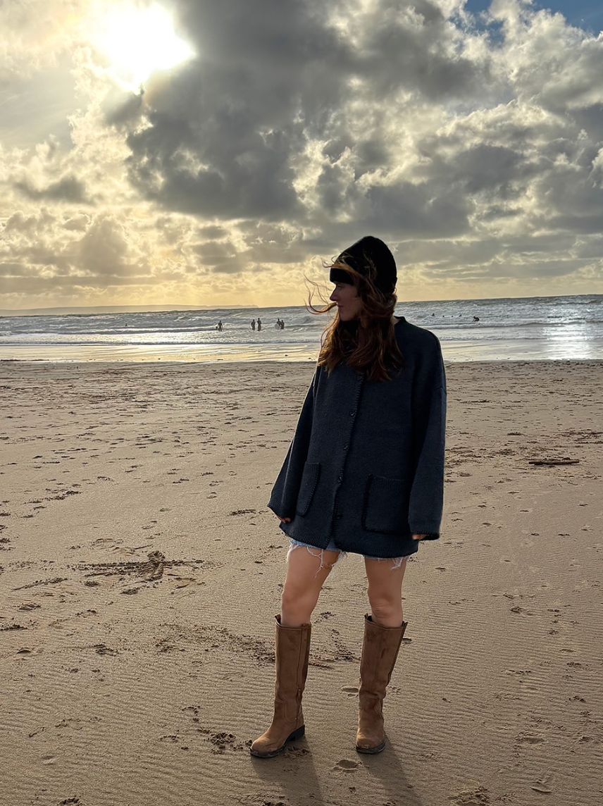 A series of five beach photos showing people walking on sandy shores at sunset with dramatic cloudy skies overhead.
