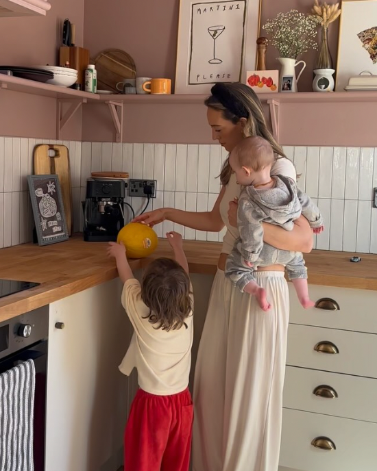 Cummins family at home cooking in their pink kitchen.